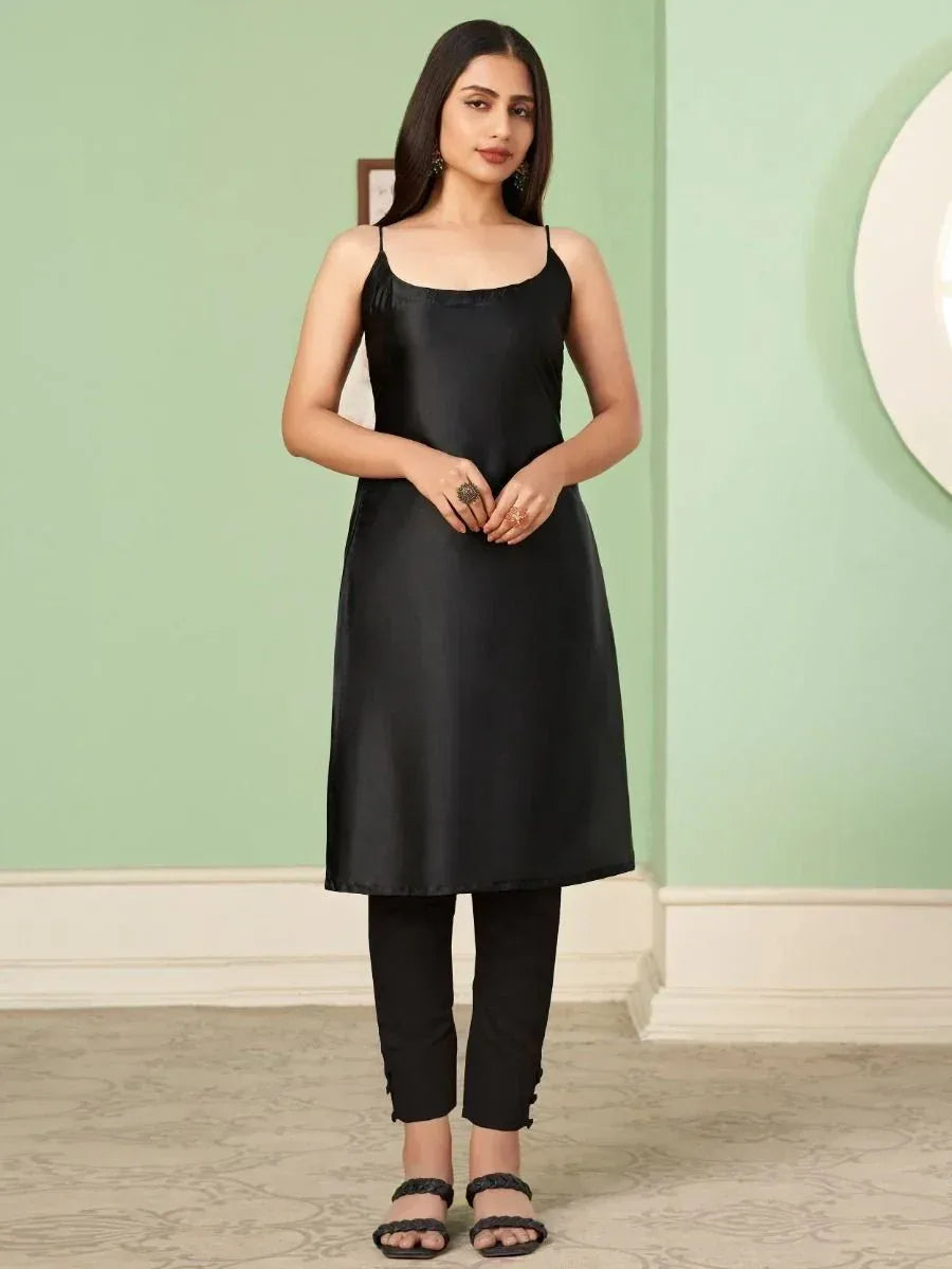 Black satin slip dress with thin straps, paired with black pants and sandals for ethnic wear styling