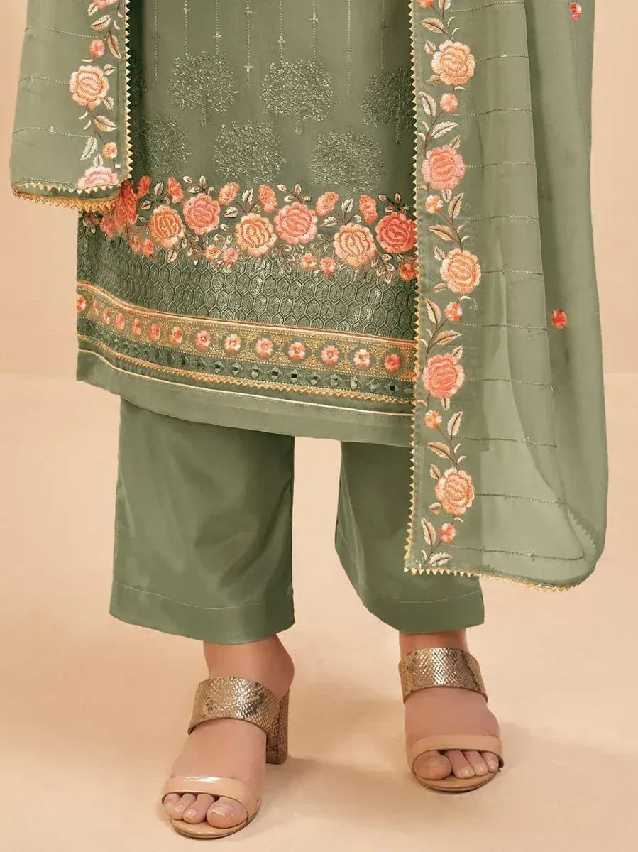 Olive green salwar kameez with floral embroidery and dupatta, paired with sandals