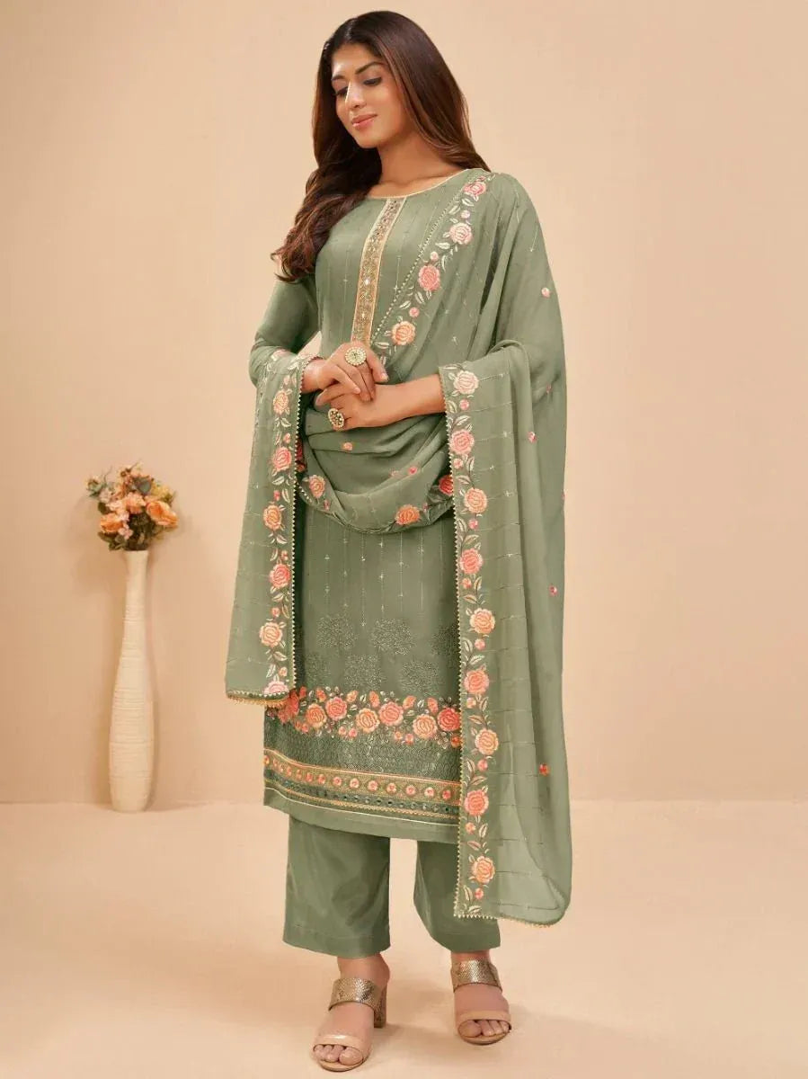 Woman in sage green embroidered salwar kameez with floral dupatta, ethnic wear