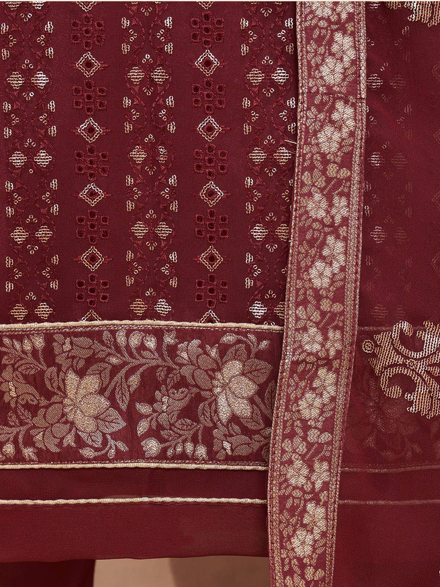 Maroon ethnic dress fabric with gold floral embroidery and intricate geometric patterns