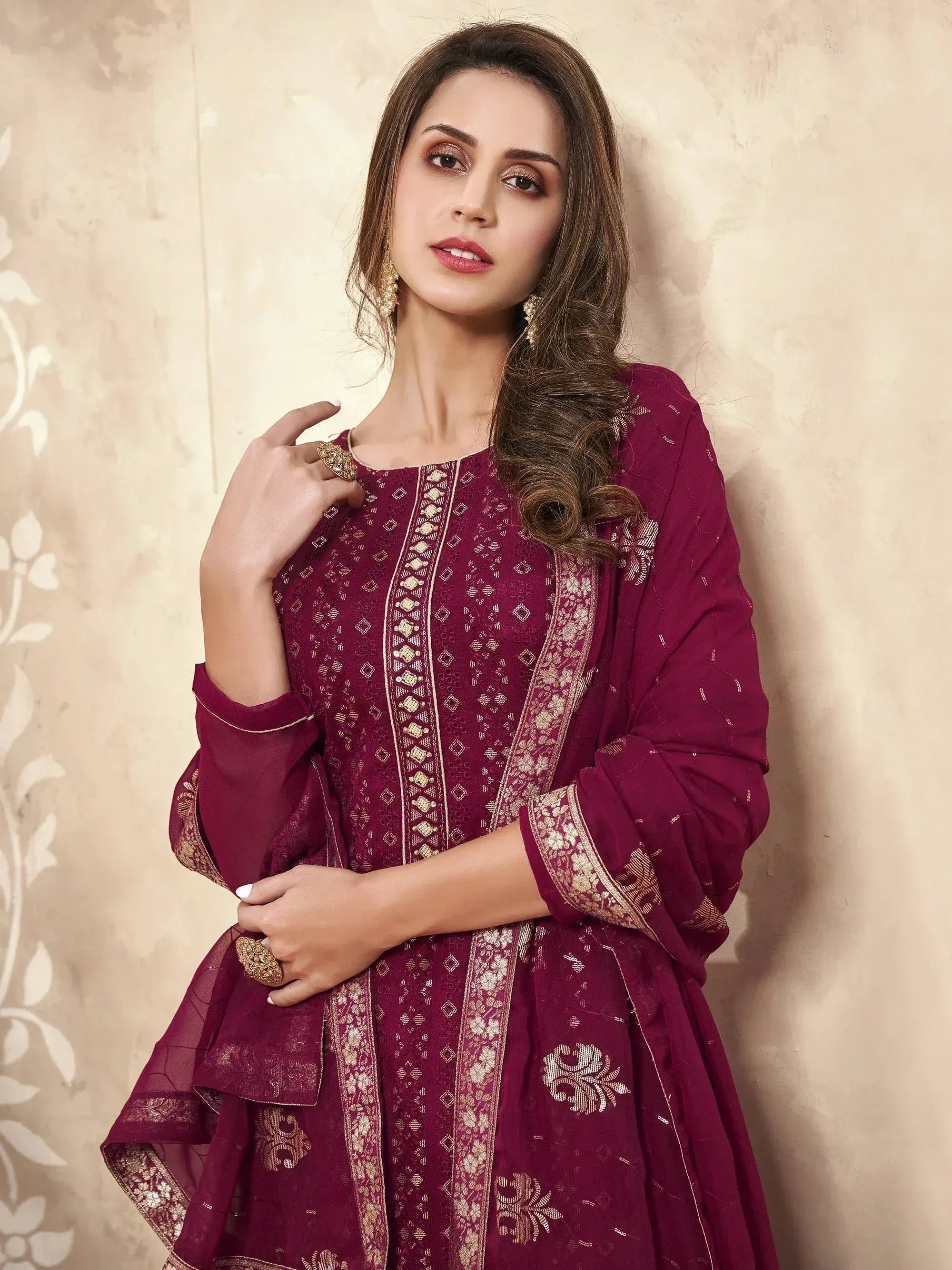 Elegant maroon ethnic gown with gold embroidery, perfect for Indian occasions and festive wear.