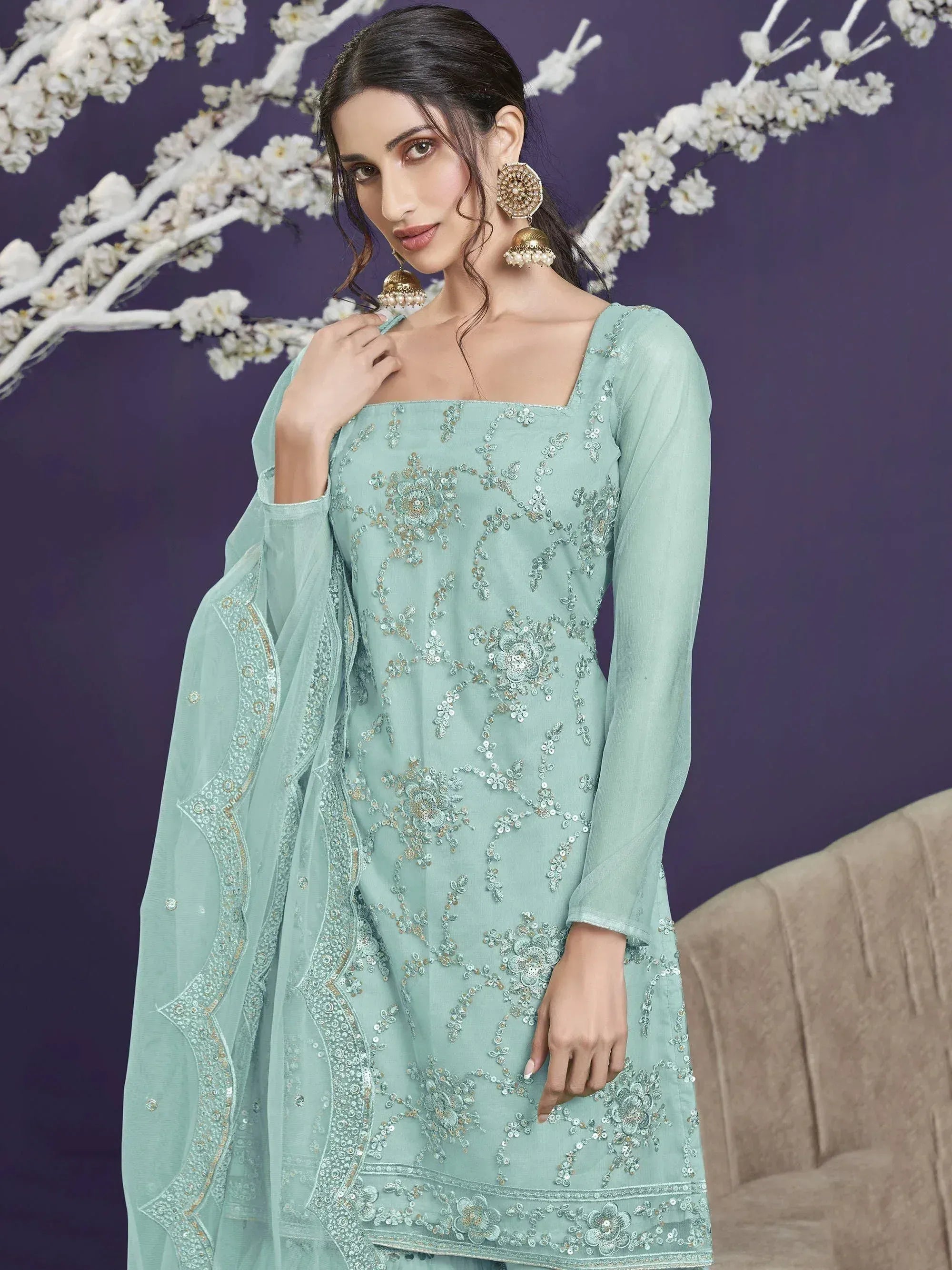Mint green embroidered salwar kameez with floral detailing and matching dupatta, perfect for ethnic occasions.