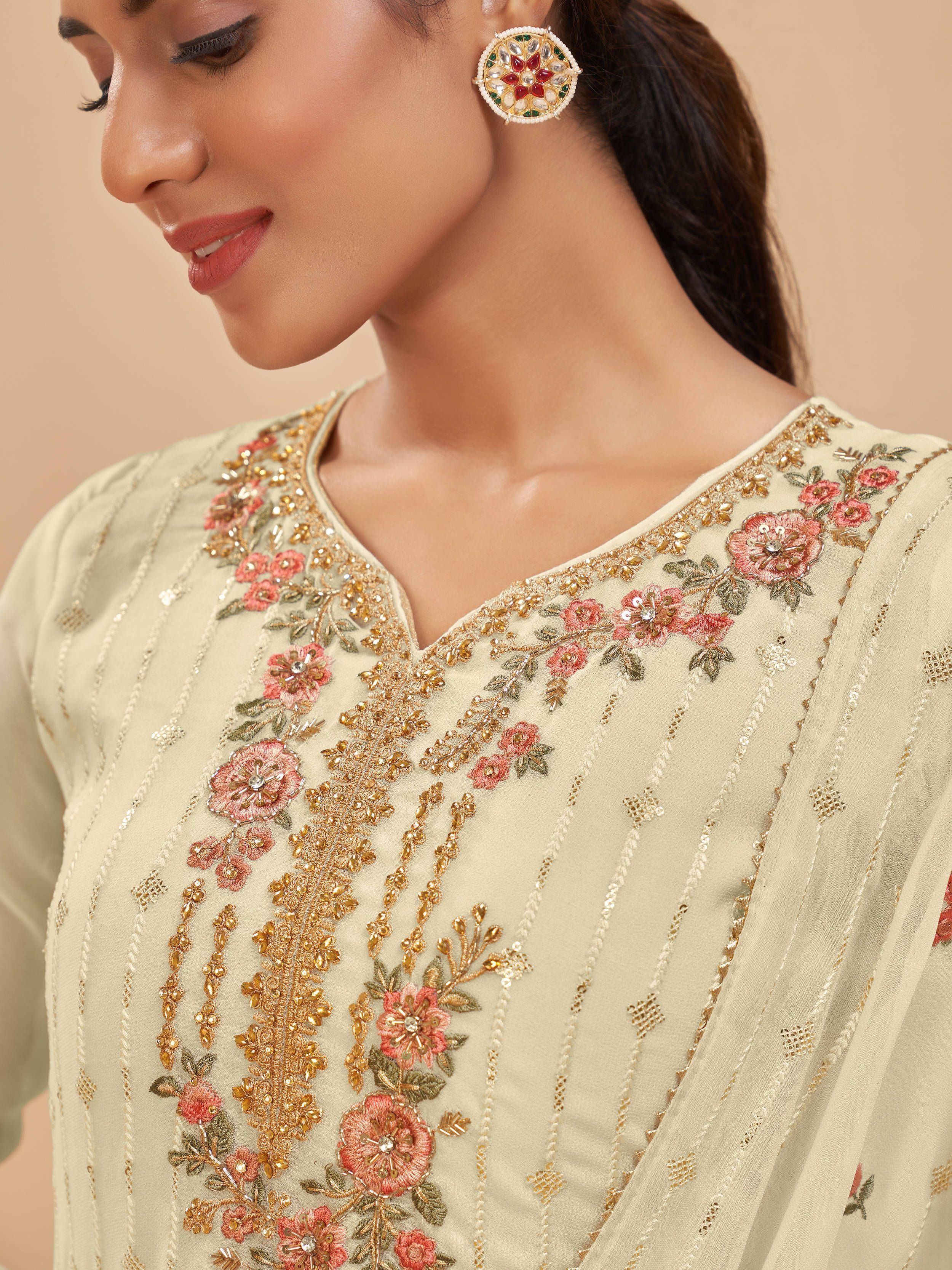 Woman wearing cream embroidered salwar kameez with floral and sequins detailing