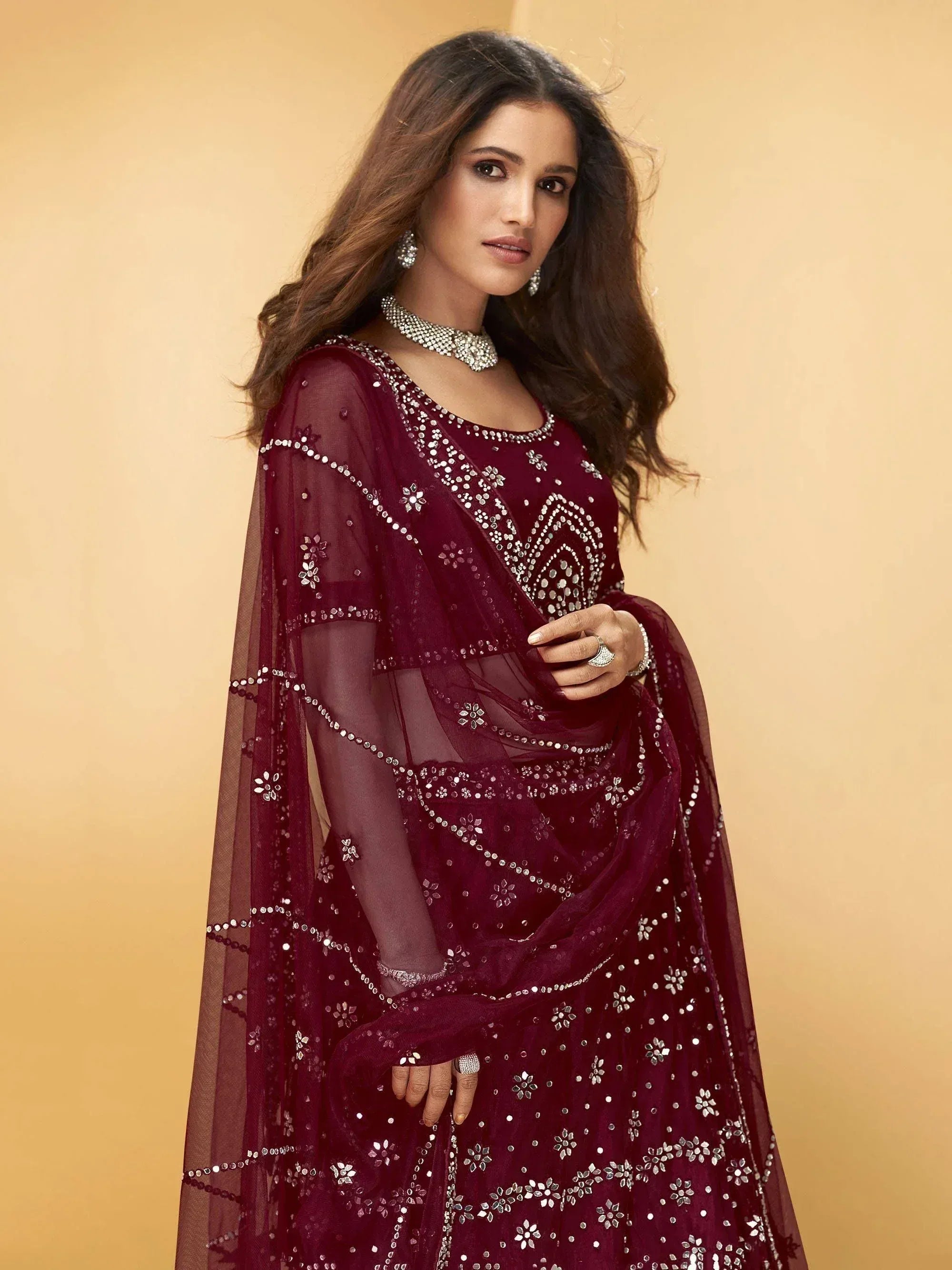 Elegant maroon ethnic gown with silver mirror work and sheer cape, perfect for Indian celebrations
