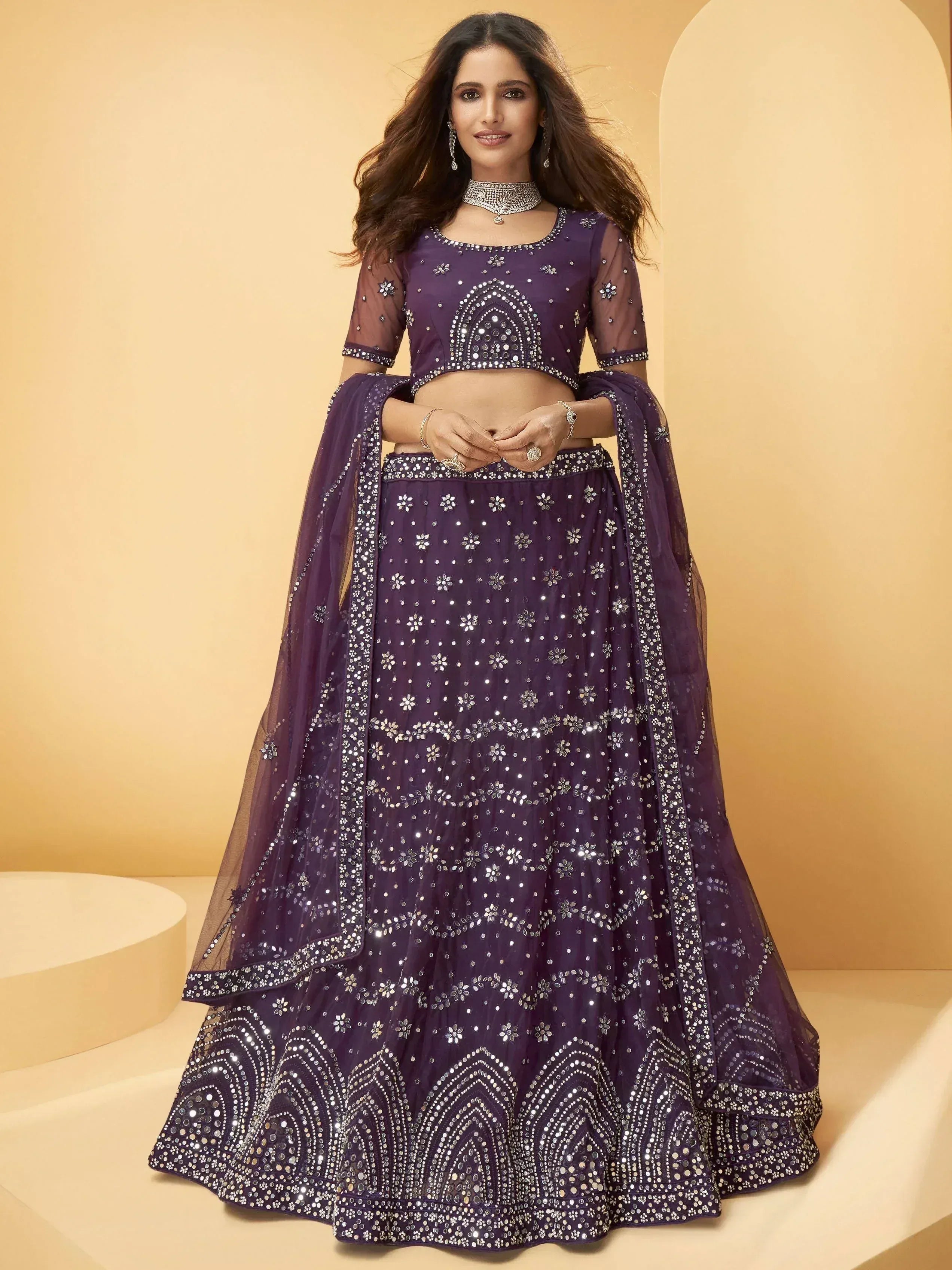 Purple embroidered lehenga choli with mirror work, perfect for Indian weddings and festive occasions