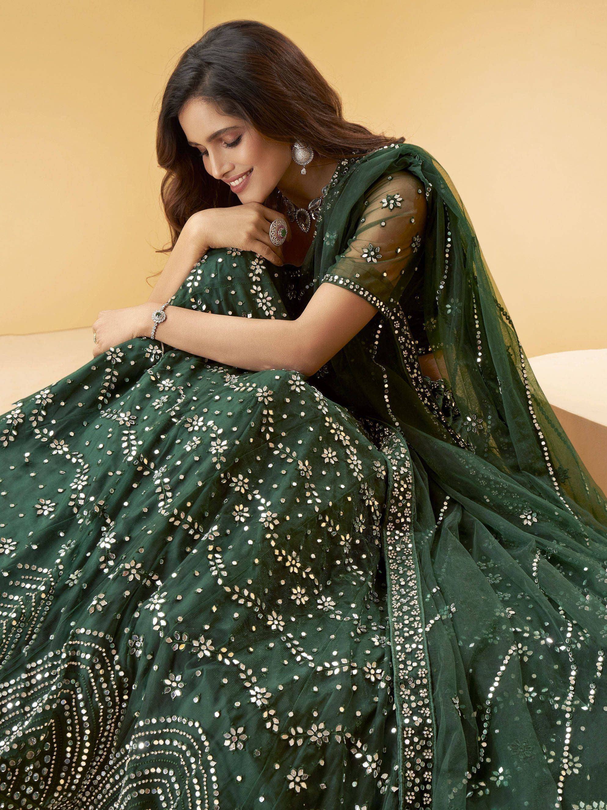 Emerald green designer lehenga choli with mirror work, perfect for Indian weddings and festive occasions.