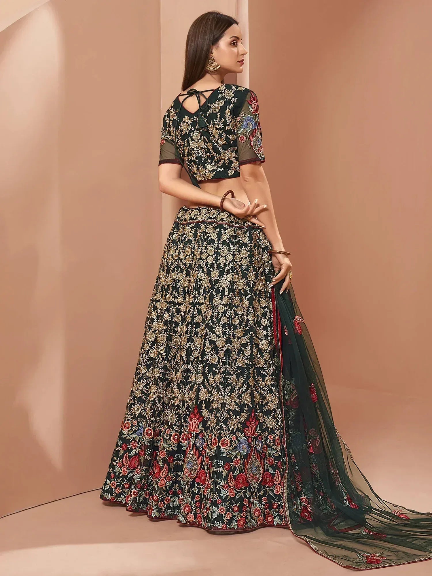 Elegant dark green lehenga choli with floral embroidery and sheer dupatta, perfect for Indian ethnic wear occasions.