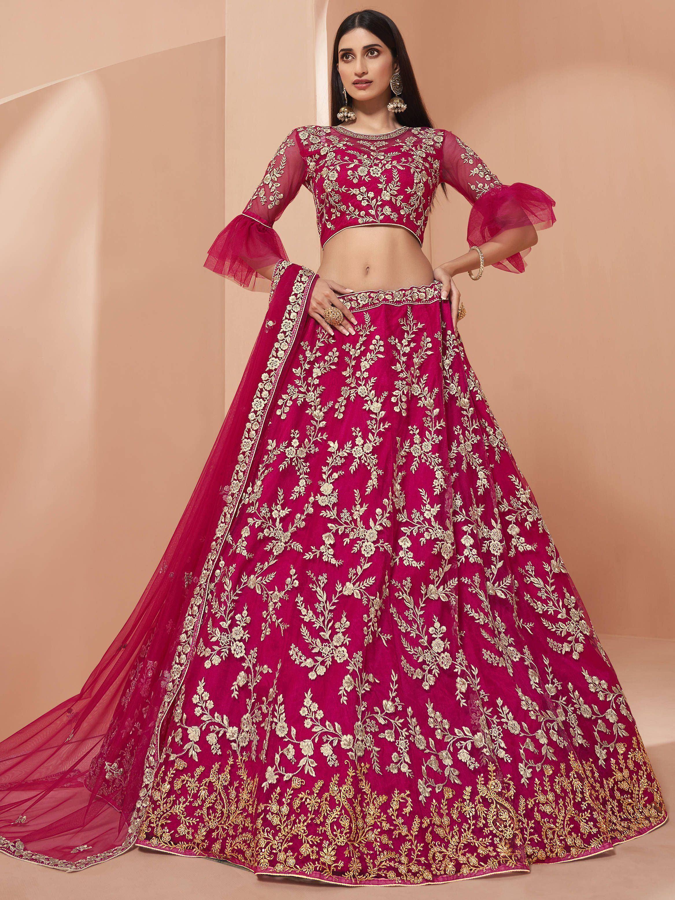 Fuchsia lehenga choli with gold floral embroidery, sheer bell sleeves, and matching dupatta for Indian ethnic wear