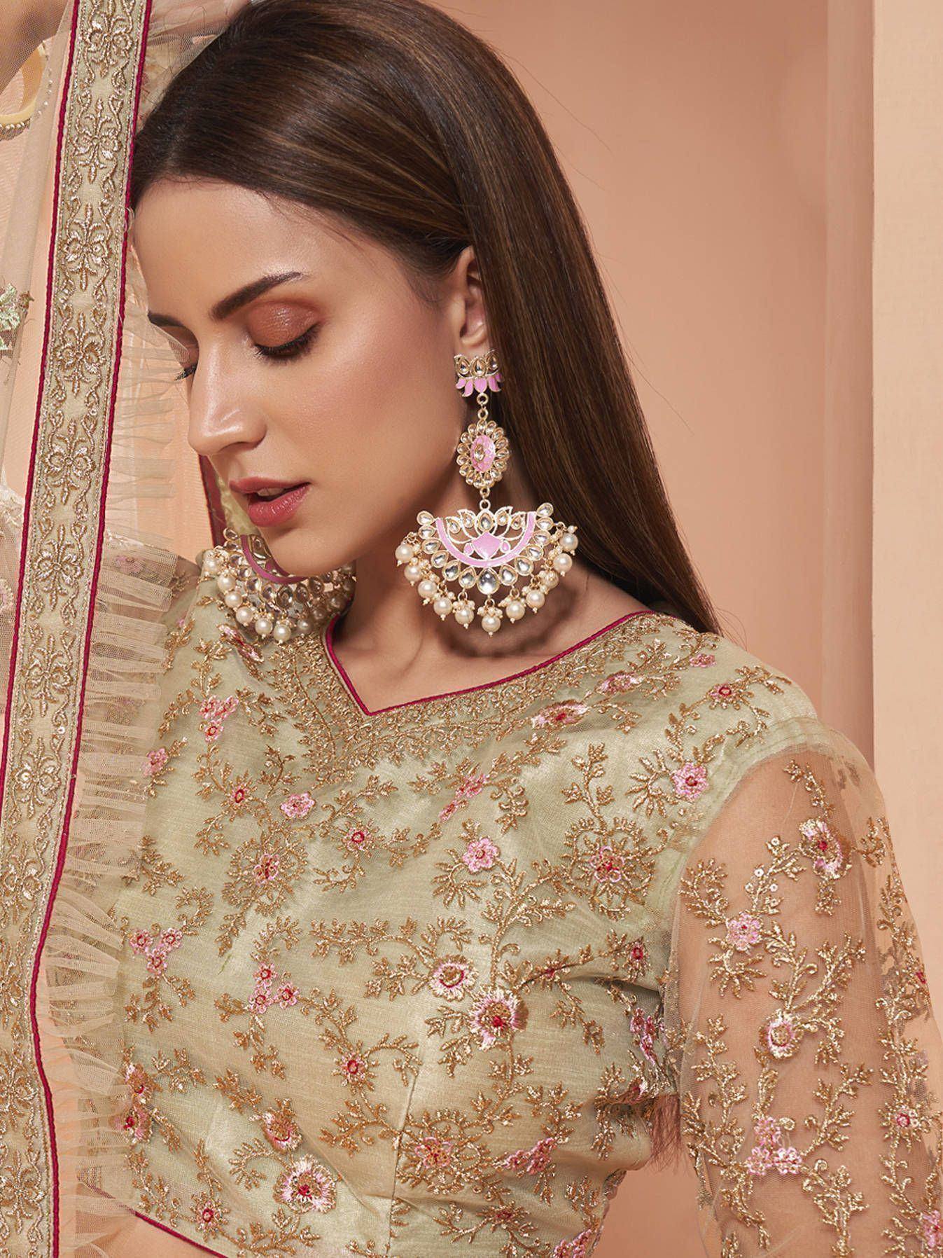 Elegant ethnic wear with floral embroidery, pink accents, and traditional jhumka earrings for Indian occasions