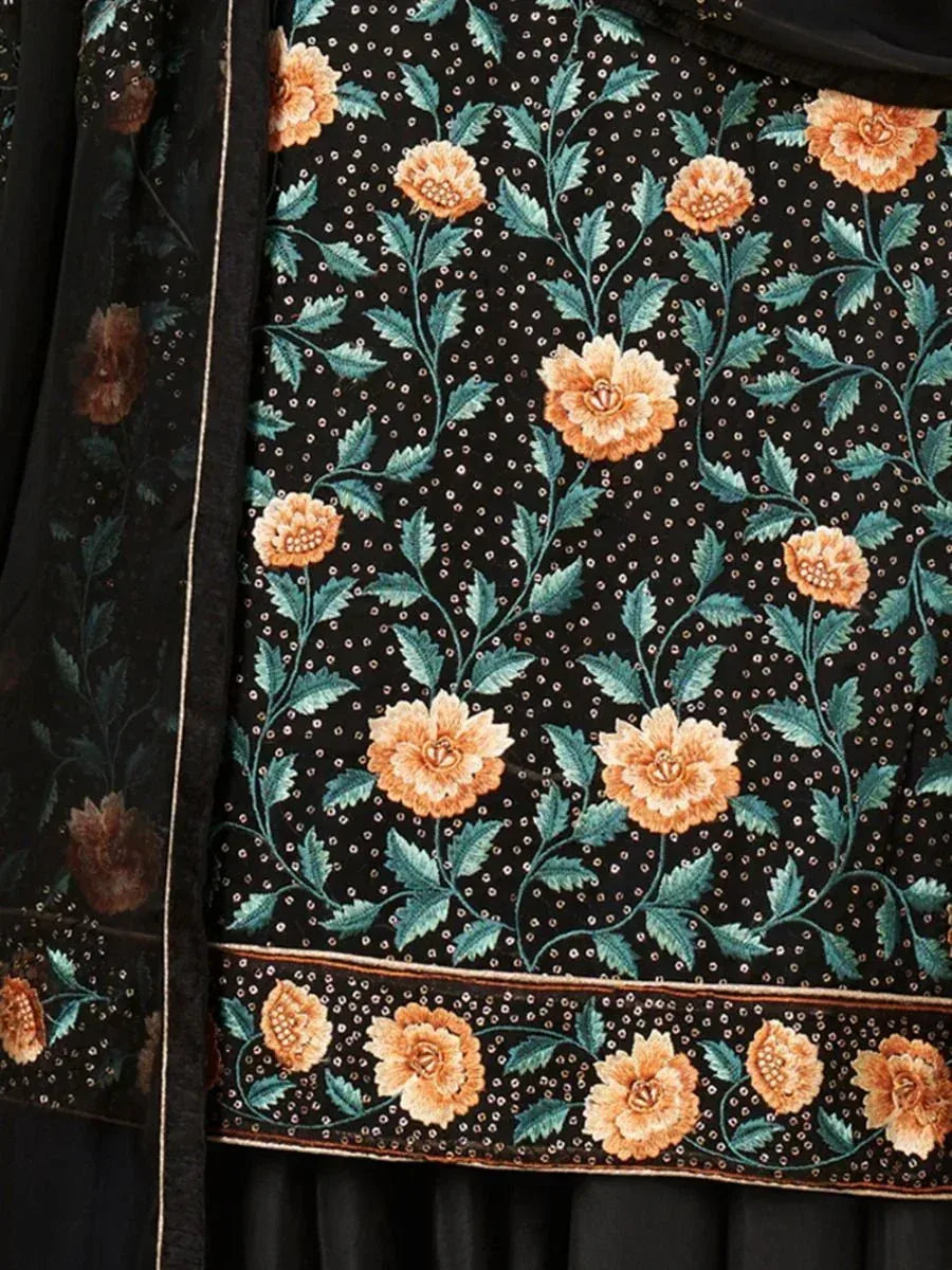Black ethnic wear with orange floral embroidery and green leaves, perfect for Indian occasions