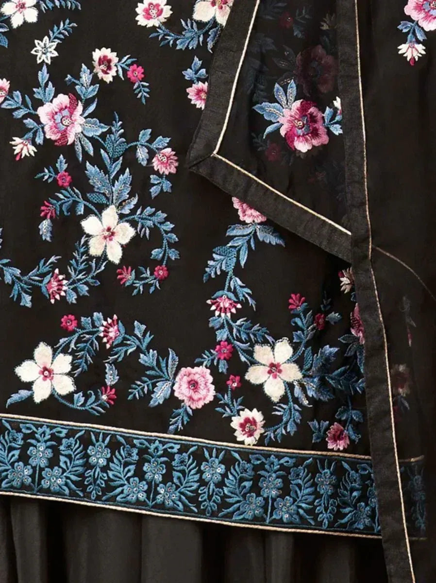 Black ethnic fabric with blue, white, and pink floral embroidery, detailed border design