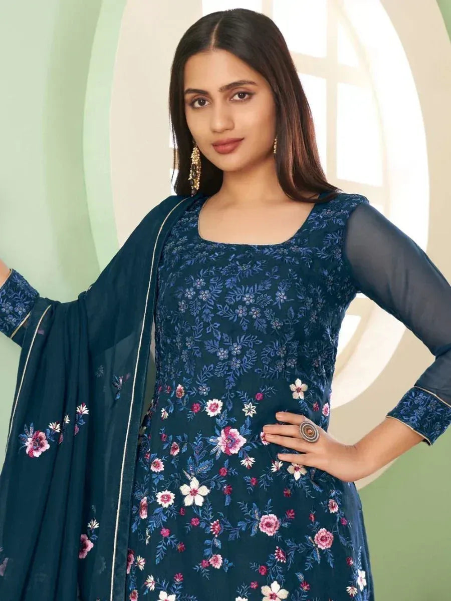 Woman wearing navy blue floral embroidered salwar kameez with chiffon dupatta