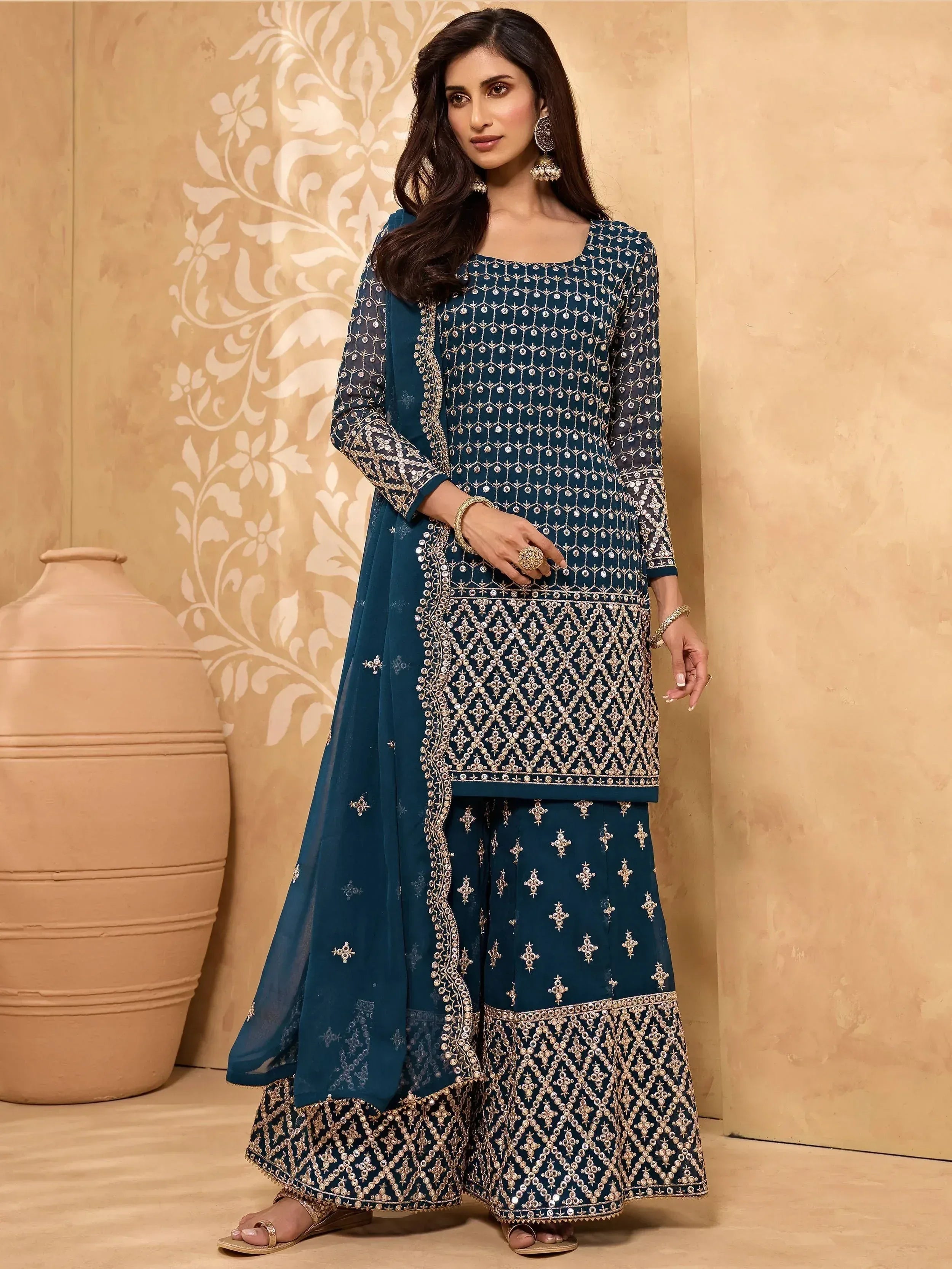 Teal blue embroidered salwar kameez with gold detailing, perfect for Indian ethnic wear occasions.