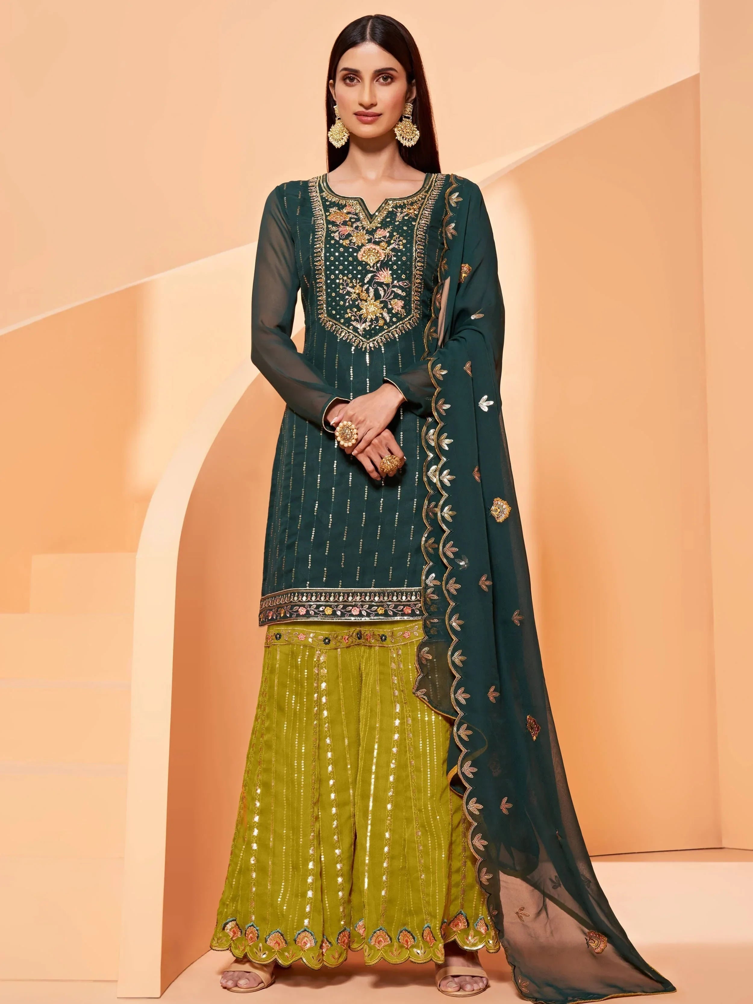 Woman wearing embroidered green kurti with matching dupatta and yellow sharara, ethnic outfit