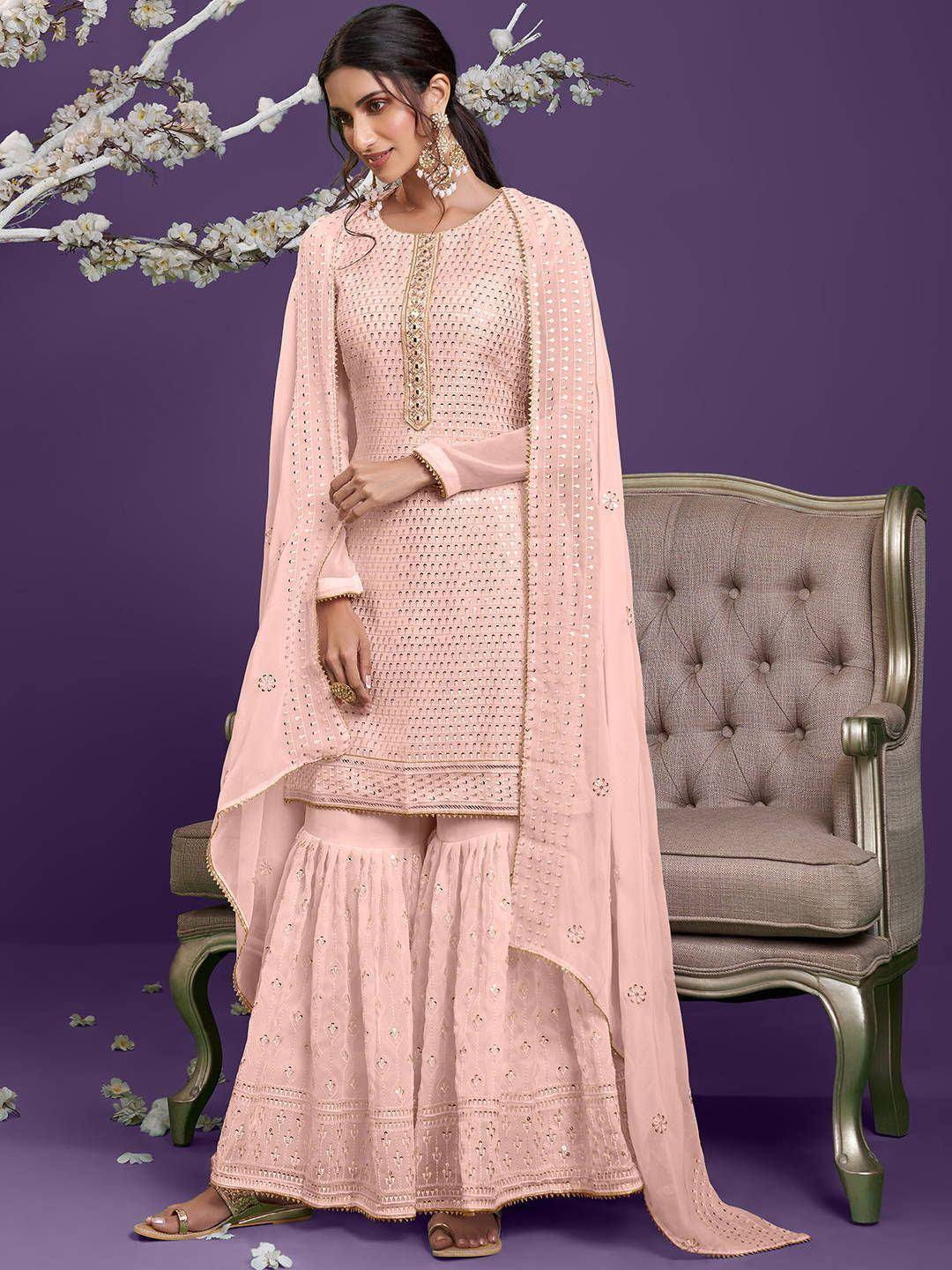 Woman in light pink embroidered sharara suit with dupatta, ethnic wear fashion