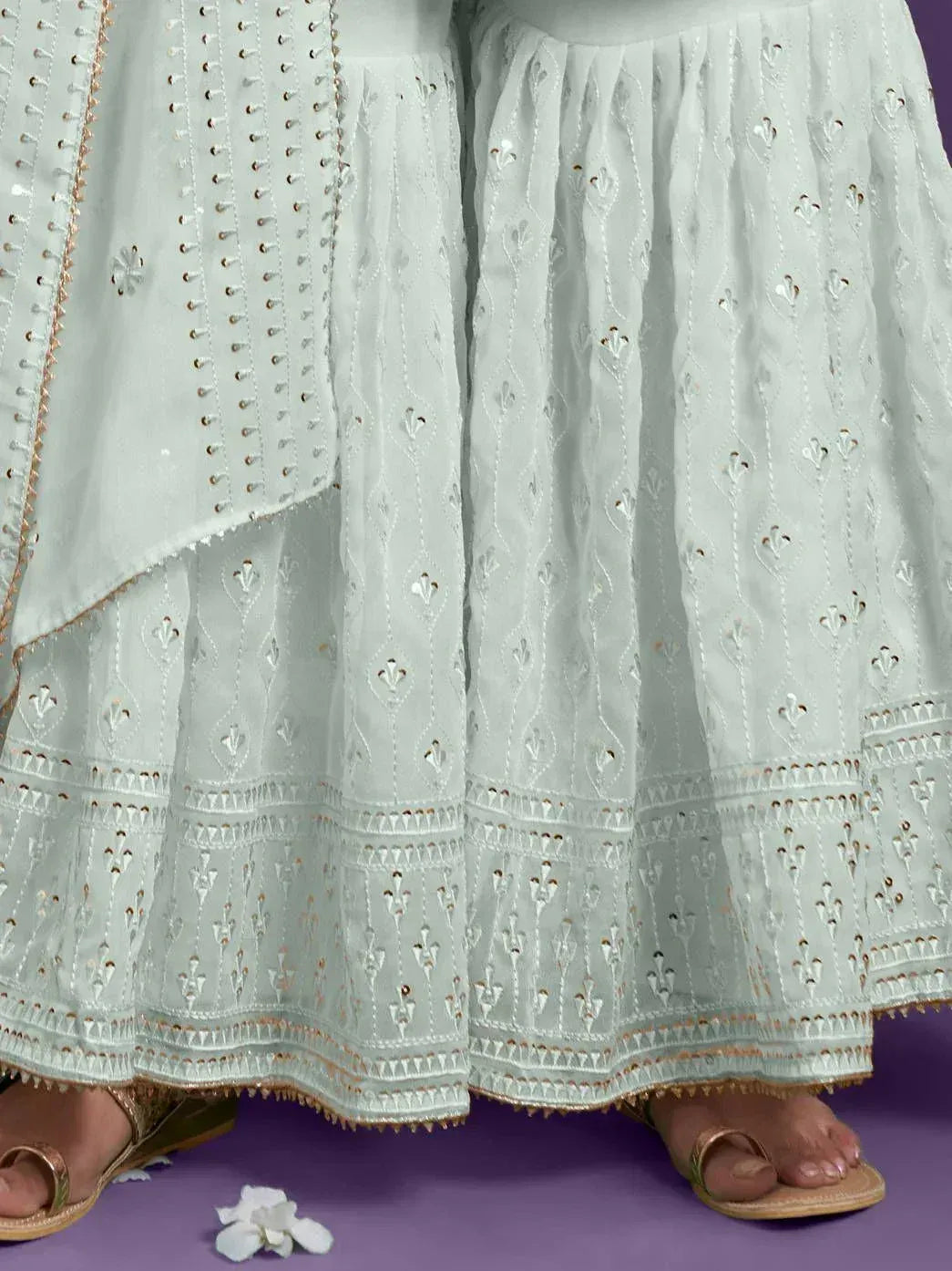 Light blue embroidered lehenga with gold detailing, paired with sandals, perfect for Indian ethnic wear occasions.
