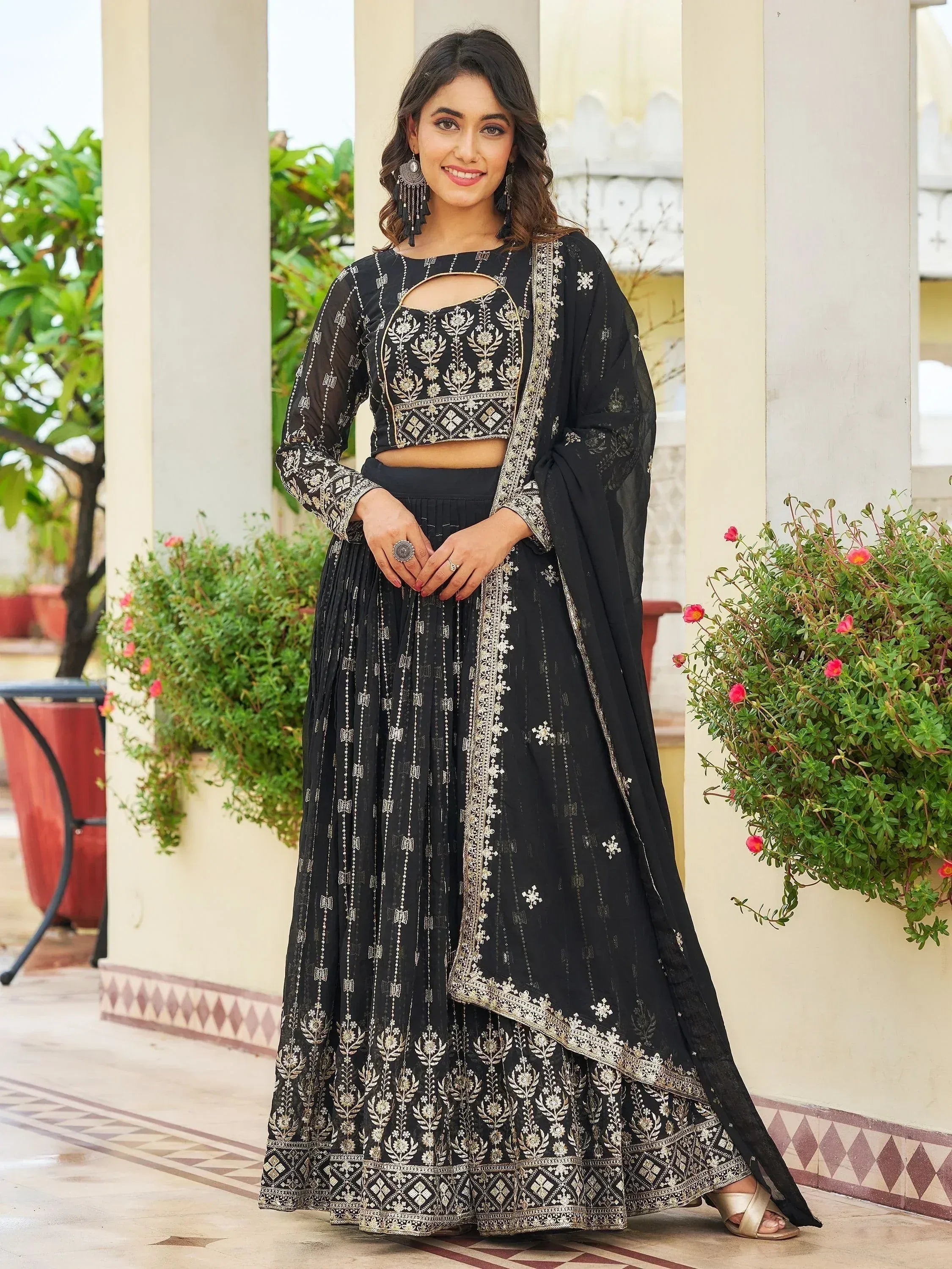 Black embroidered lehenga choli with gold detailing, perfect for Indian ethnic wear occasions.