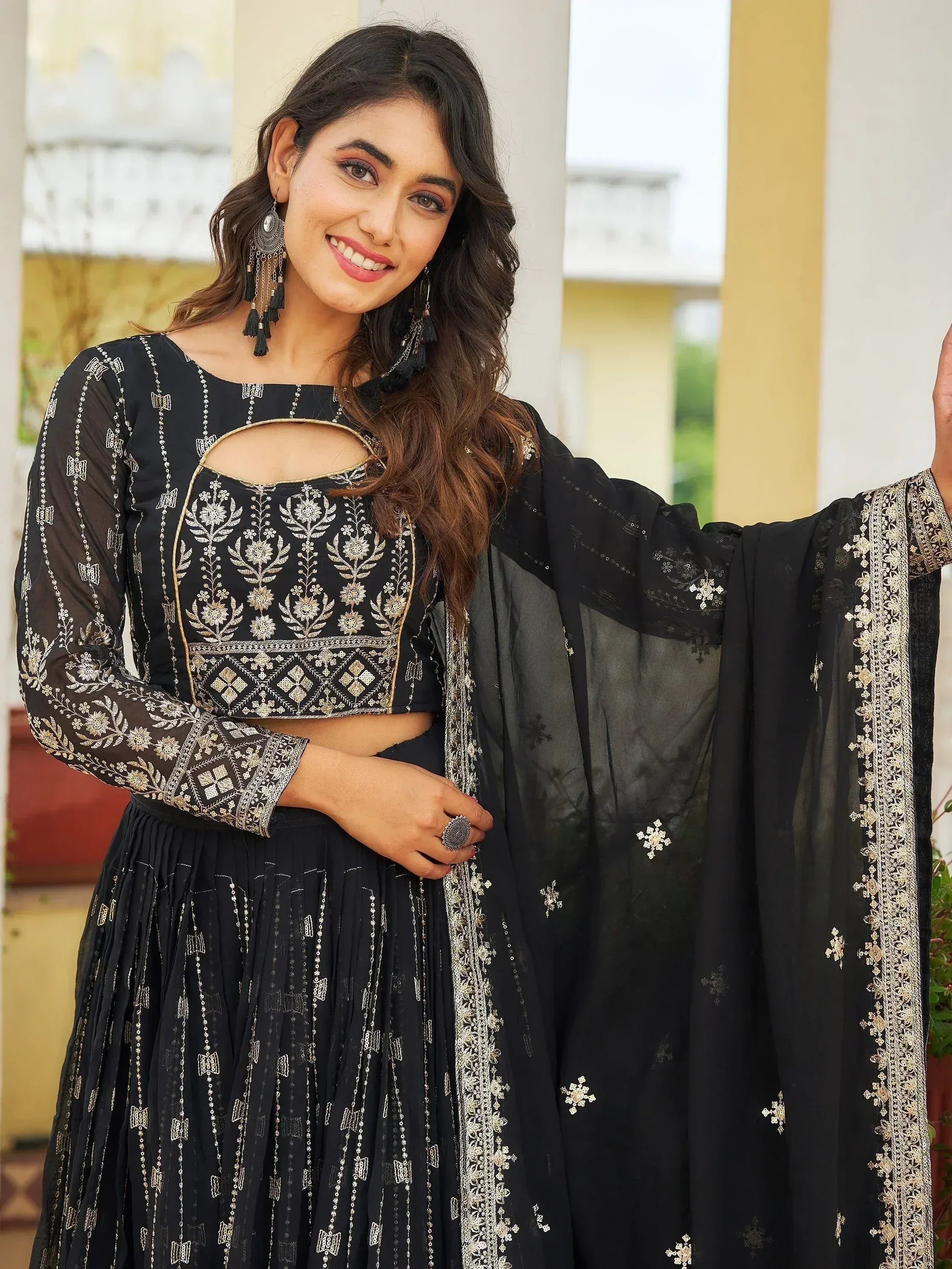 Black embroidered lehenga choli with gold detailing and sheer dupatta for ethnic wear