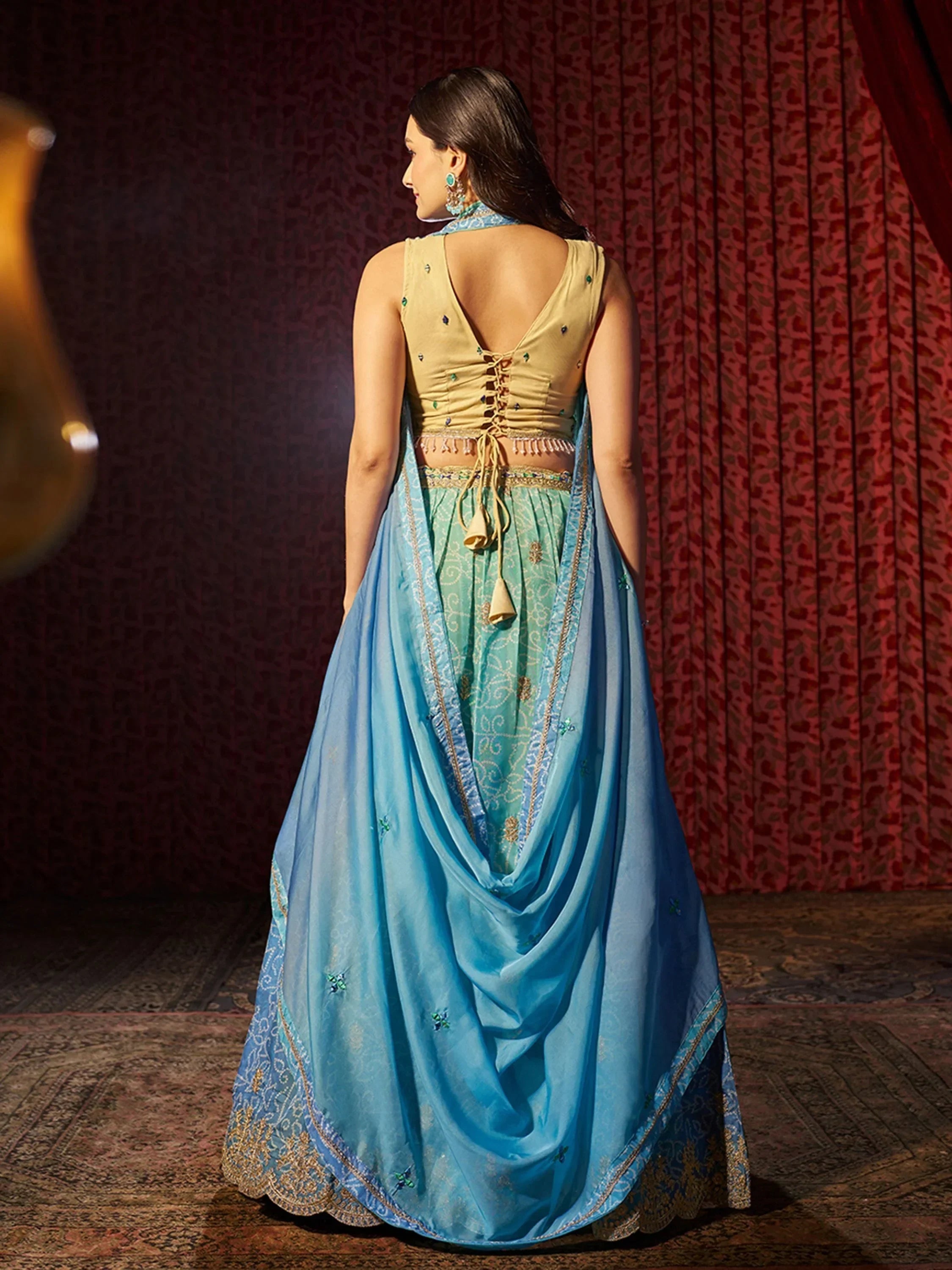 Blue and gold designer lehenga choli with back lace-up detail, perfect for Indian ethnic wear occasions