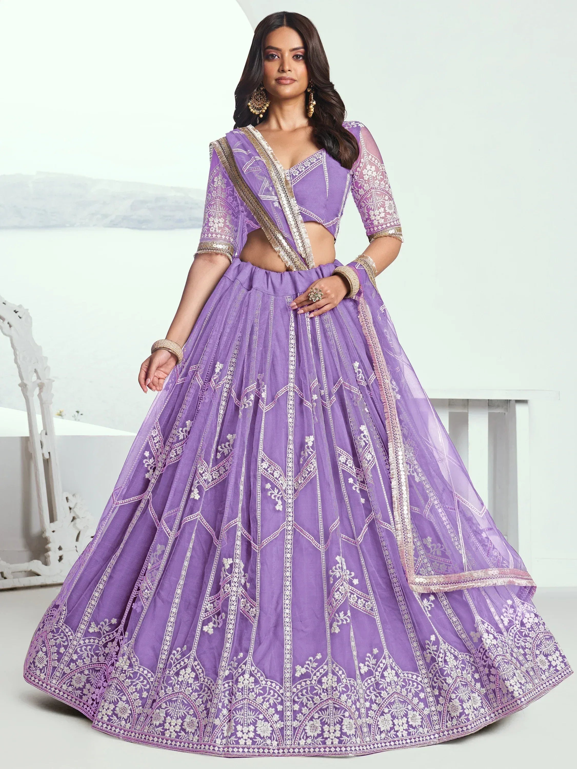 Purple embroidered lehenga choli with sheer dupatta, perfect for Indian weddings and festive occasions.
