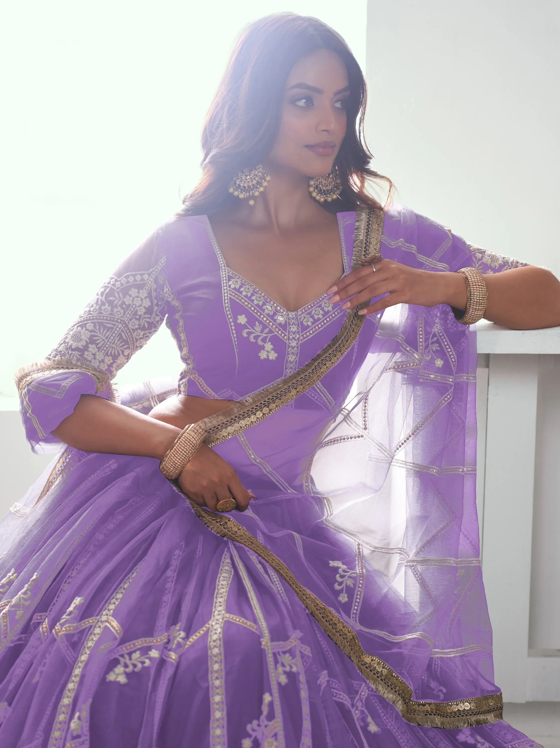 Purple designer lehenga choli with gold embroidery and sheer dupatta, ethnic Indian wear