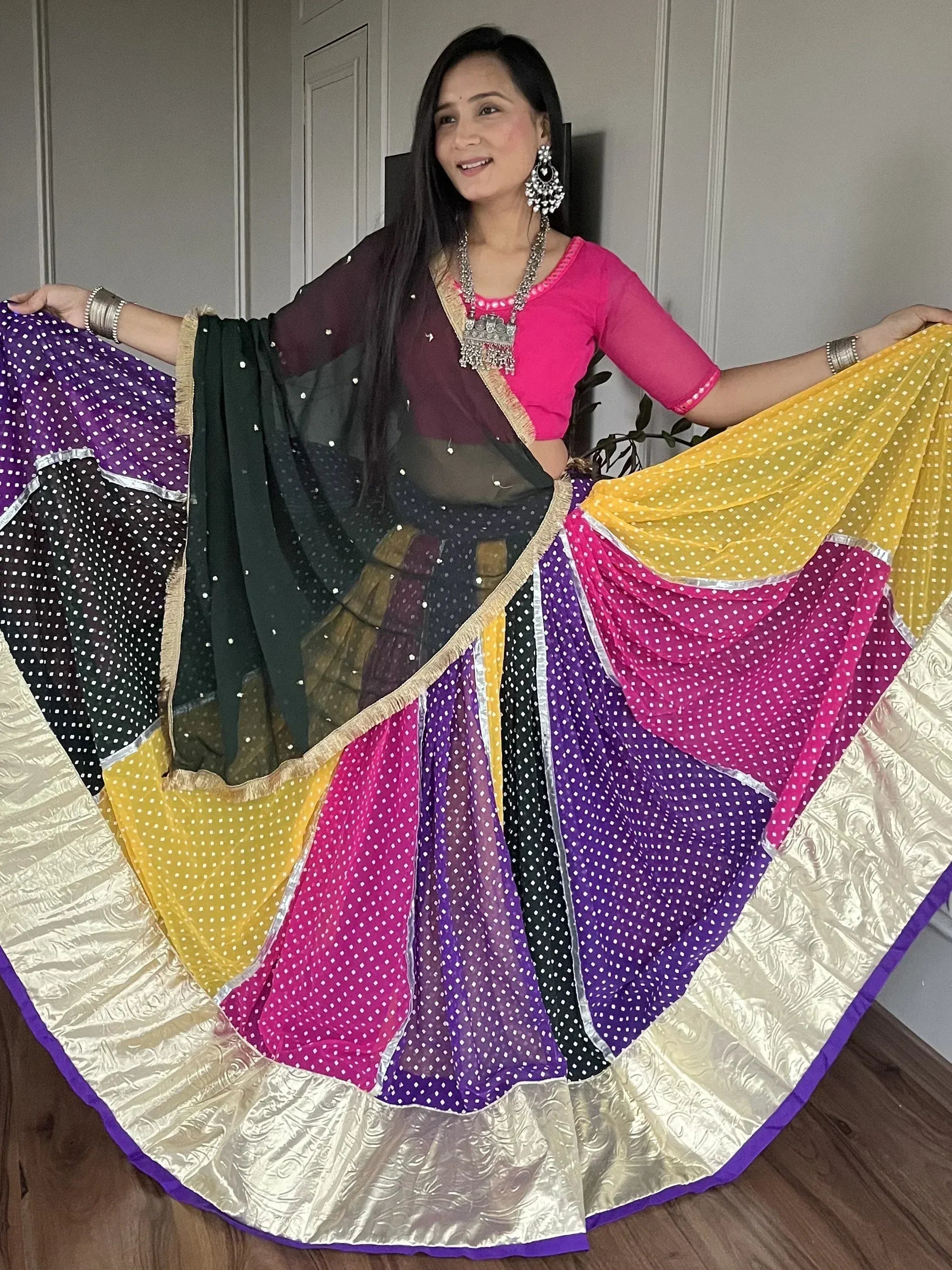 Woman in vibrant polka dot lehenga choli with colorful dupatta, perfect for Indian ethnic wear events