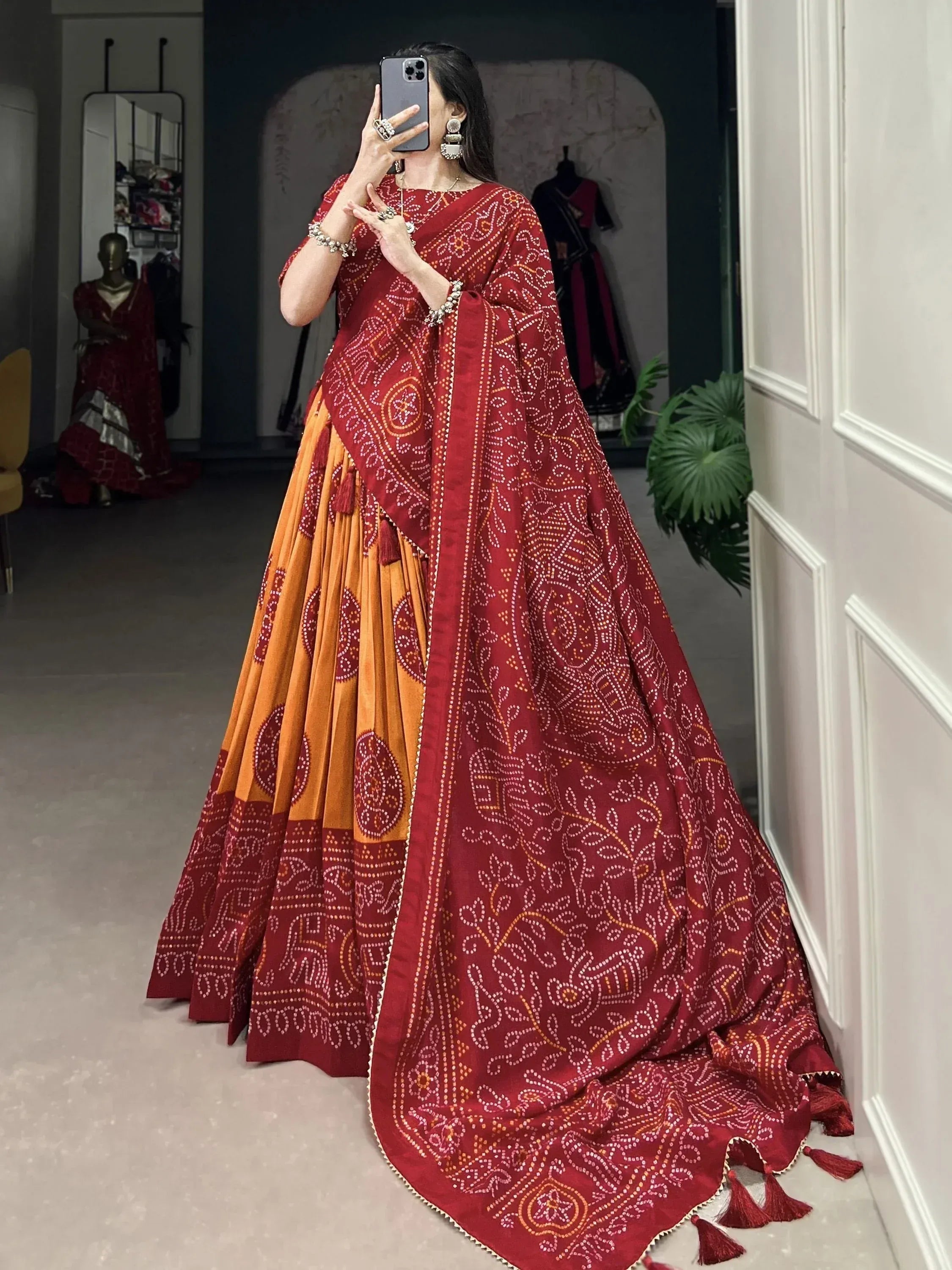 Red and orange Bandhani print lehenga choli with tassels, ethnic Indian wear for women