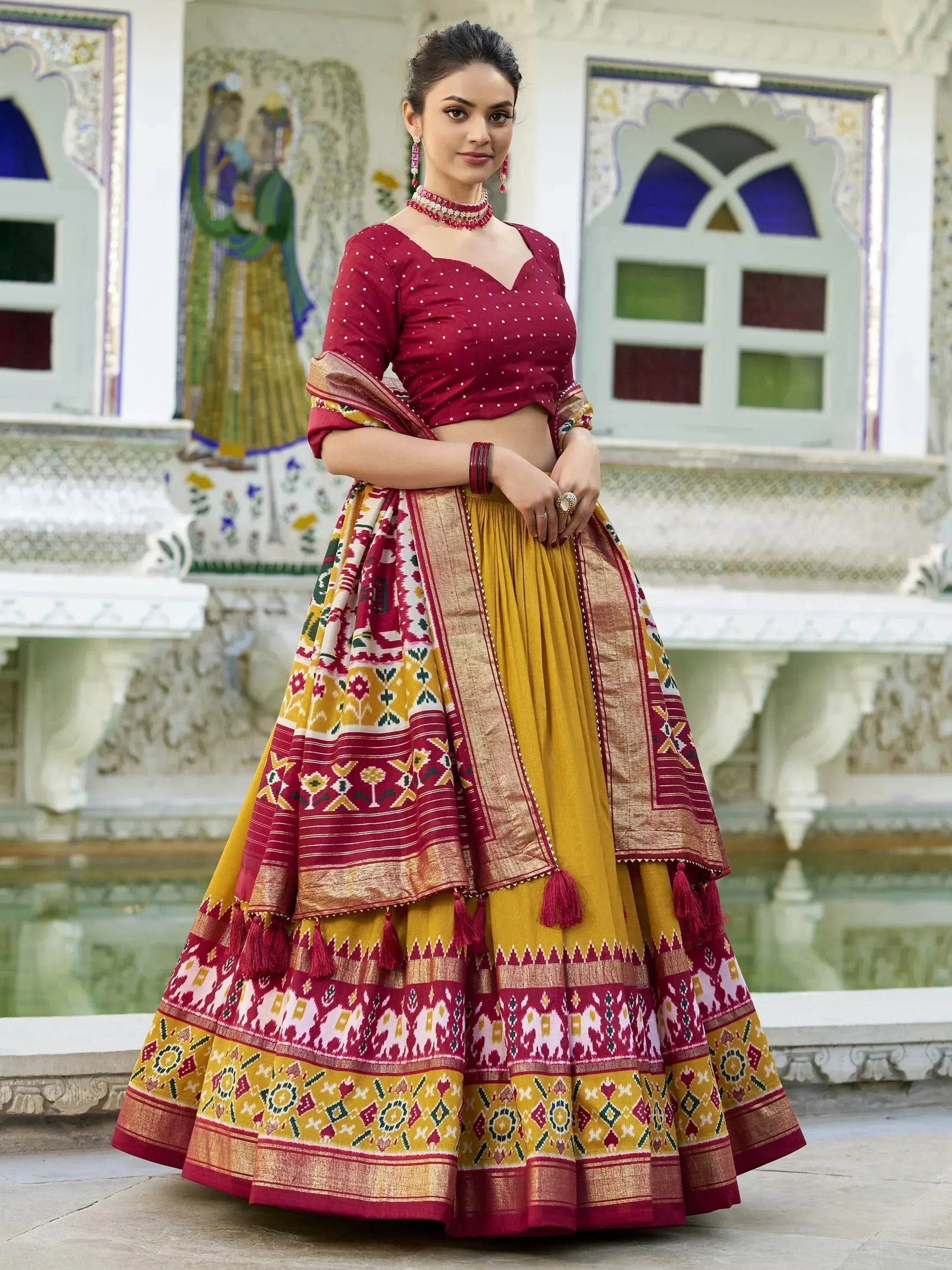 Maroon and mustard designer lehenga choli with intricate patterns, perfect for Indian ethnic wear occasions.