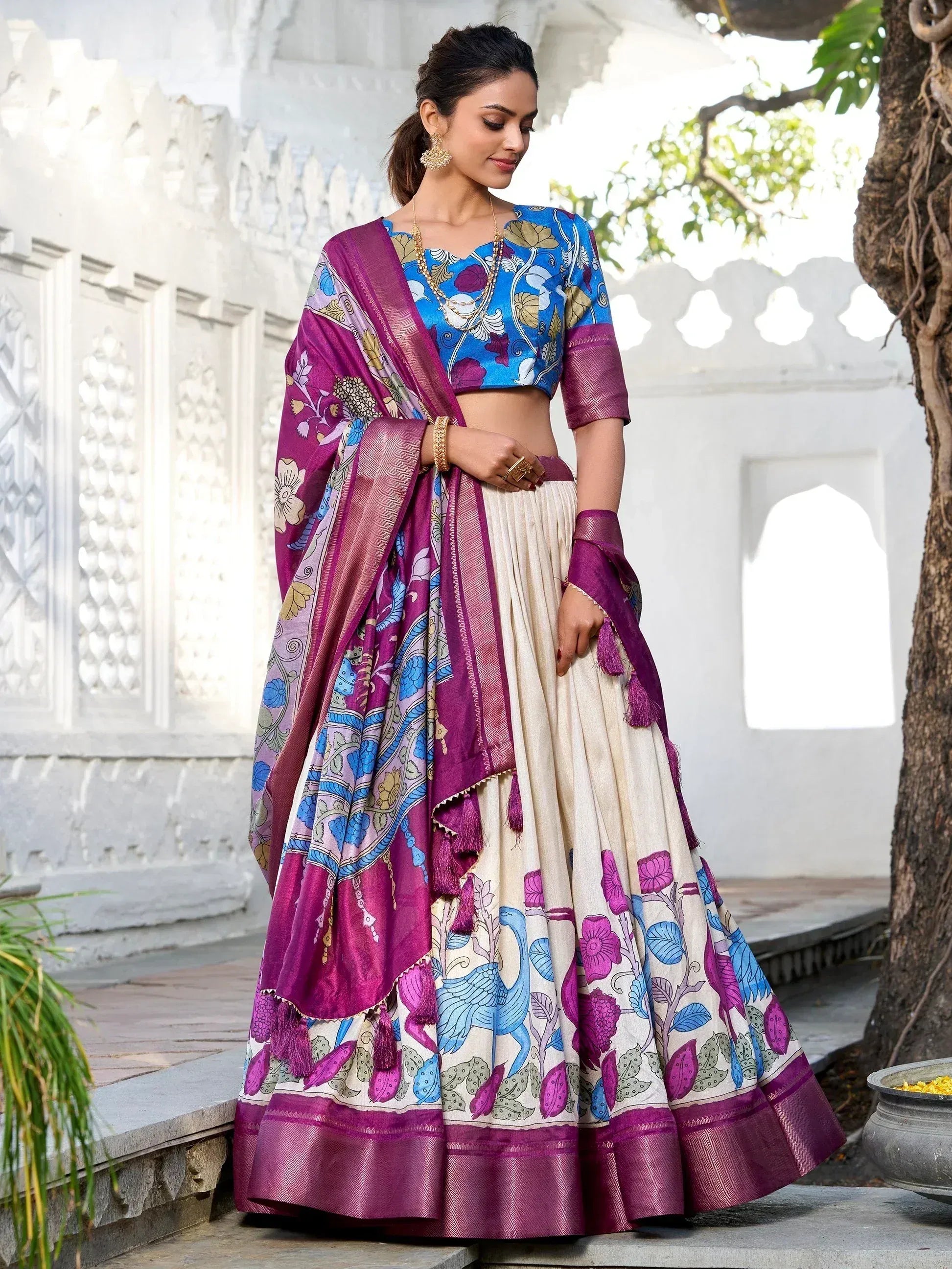 Woman in floral print lehenga choli with purple dupatta, ethnic Indian wear for festive occasions