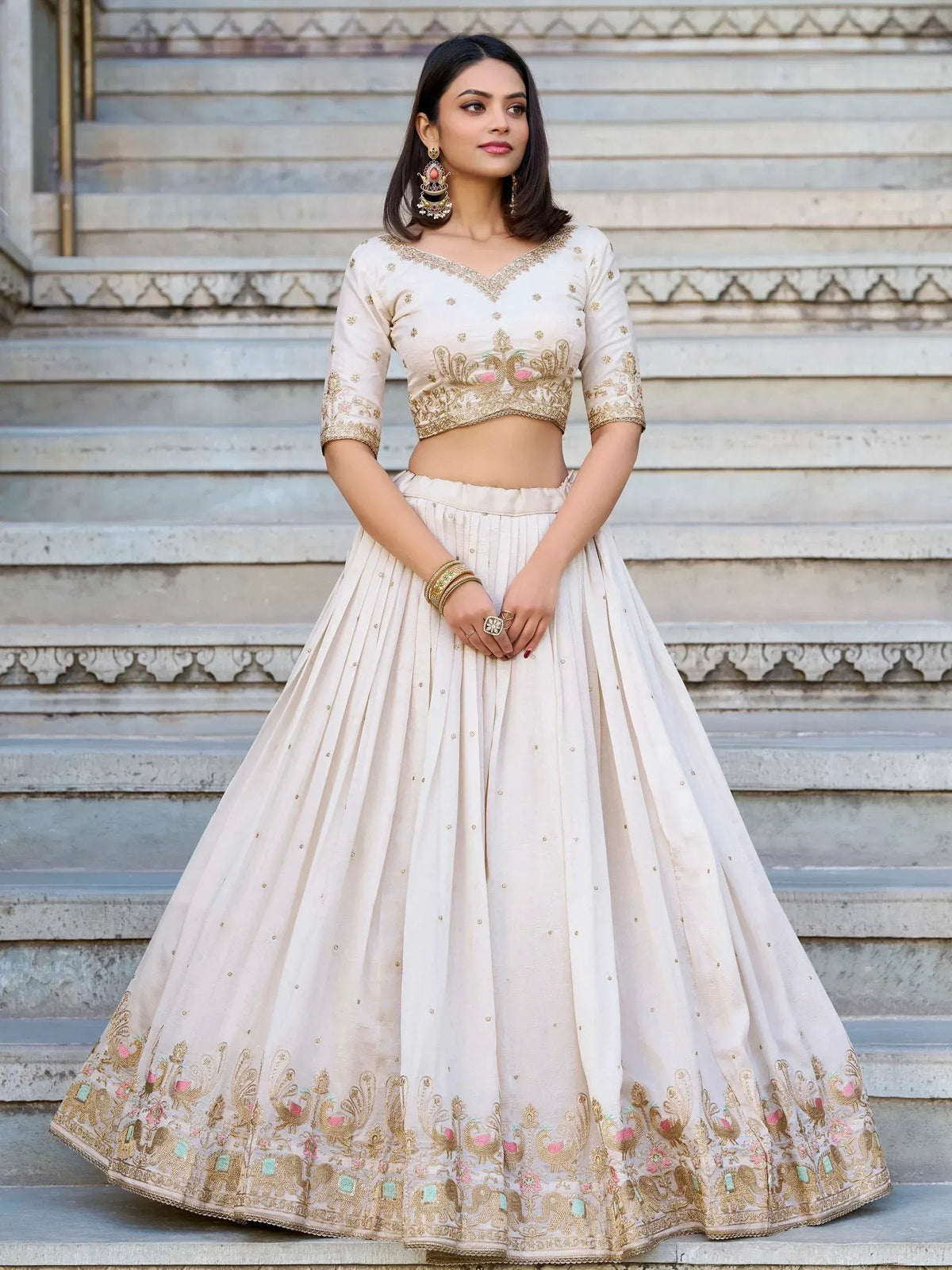 Cream embroidered lehenga choli with peacock design, perfect for Indian weddings and festive occasions.