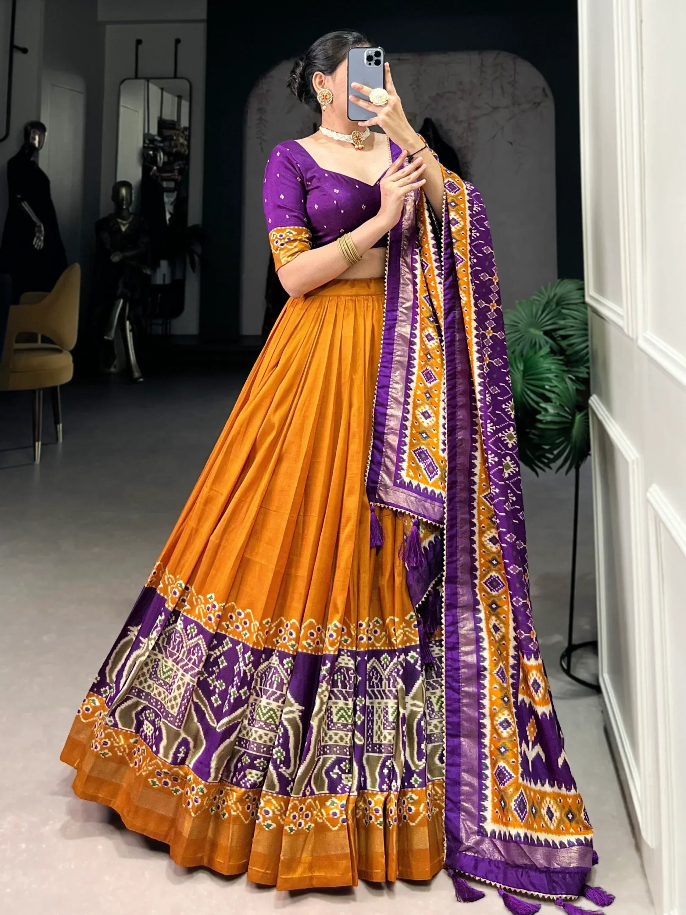 Purple and orange designer lehenga choli with intricate ikat print and matching dupatta for Indian ethnic wear