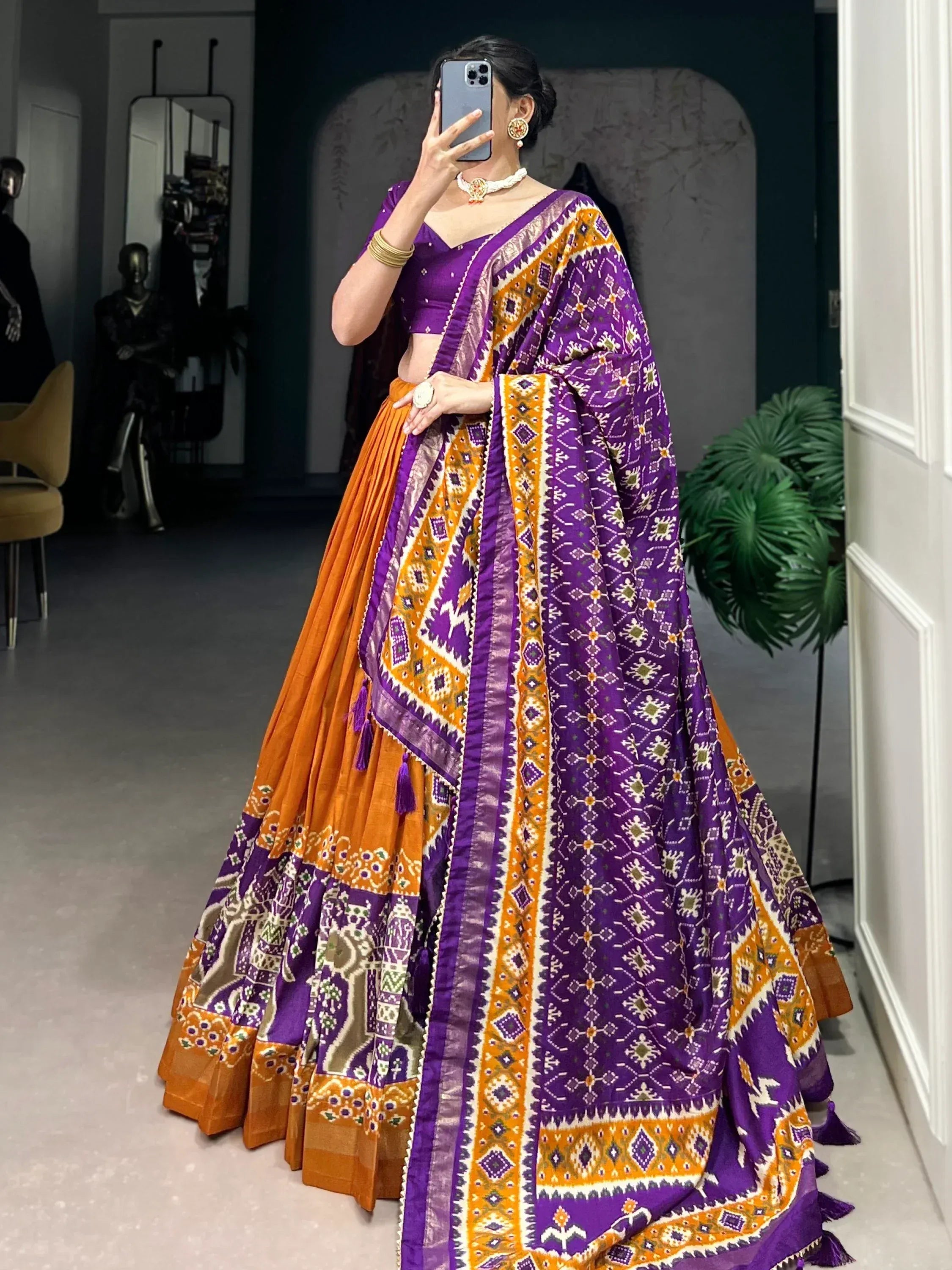 Purple and orange printed lehenga choli with ethnic patterns, perfect for Indian festive occasions