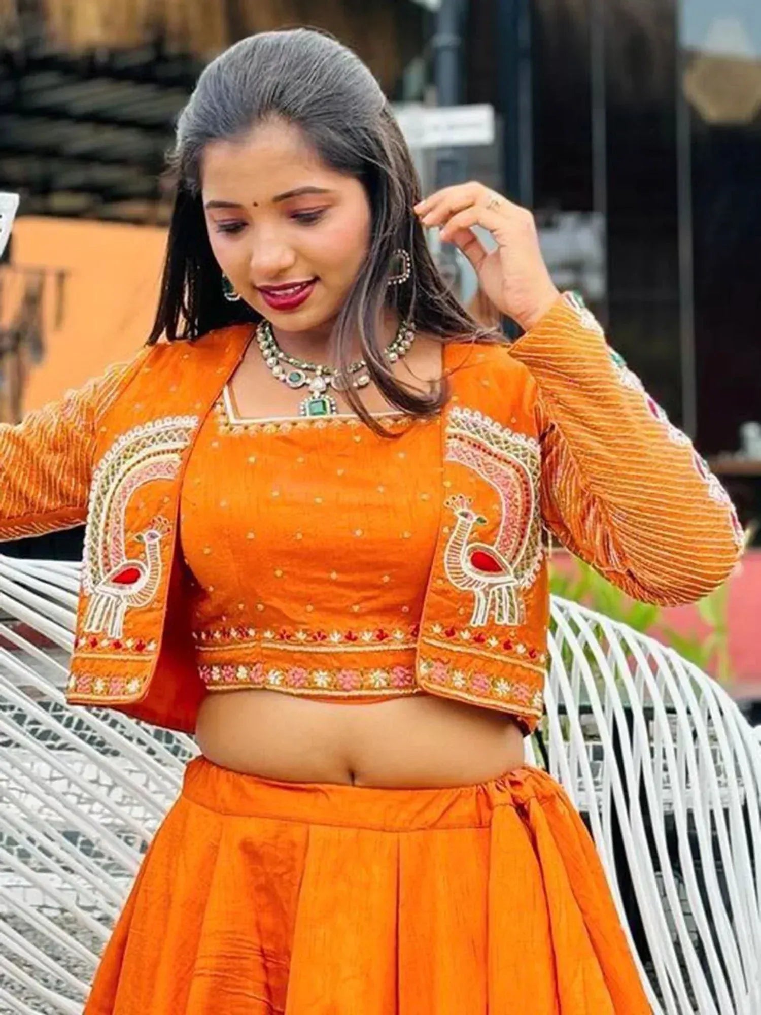 Orange embroidered lehenga choli with peacock motifs, perfect for Indian ethnic wear and festive occasions.