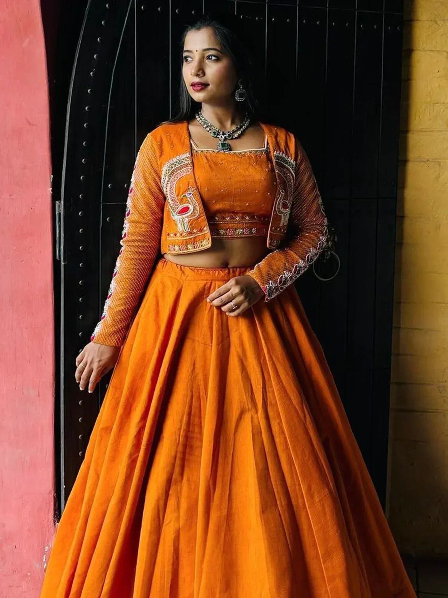 Orange embroidered lehenga choli with peacock design, perfect for Indian ethnic wear occasions