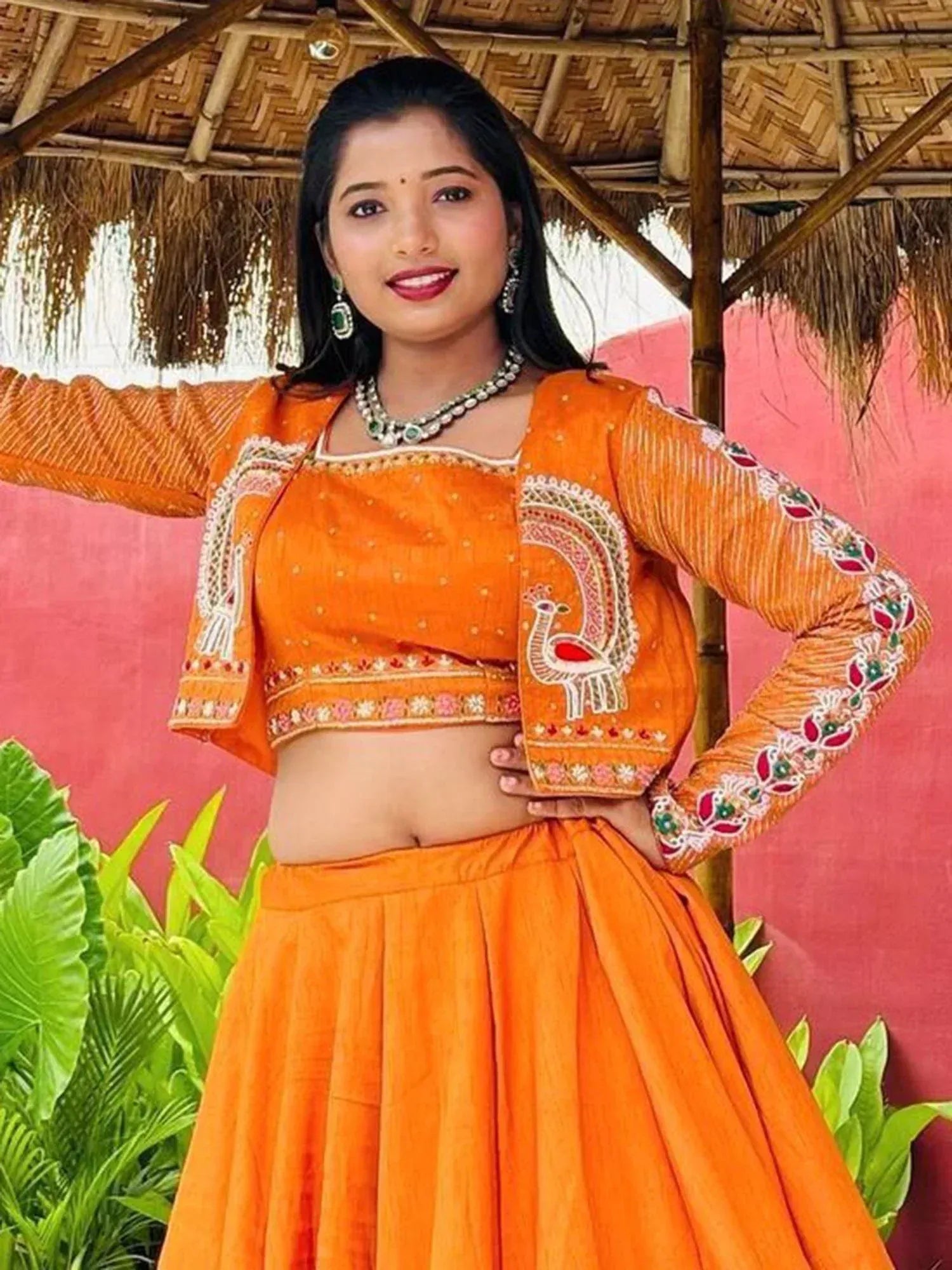 Orange embroidered lehenga choli with peacock design, perfect for Indian ethnic wear occasions