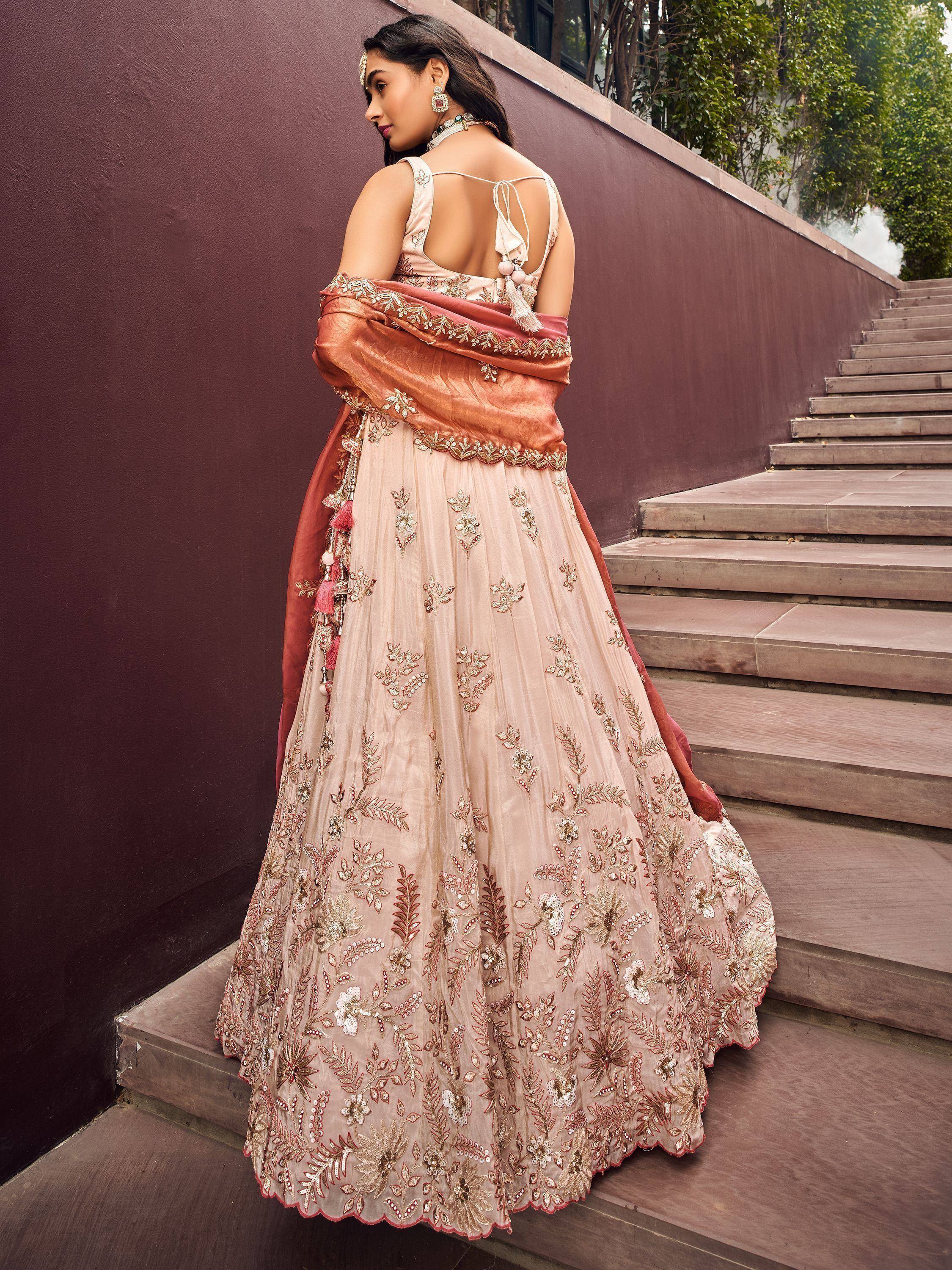 Elegant peach lehenga choli with floral embroidery, perfect for Indian weddings and festive occasions.