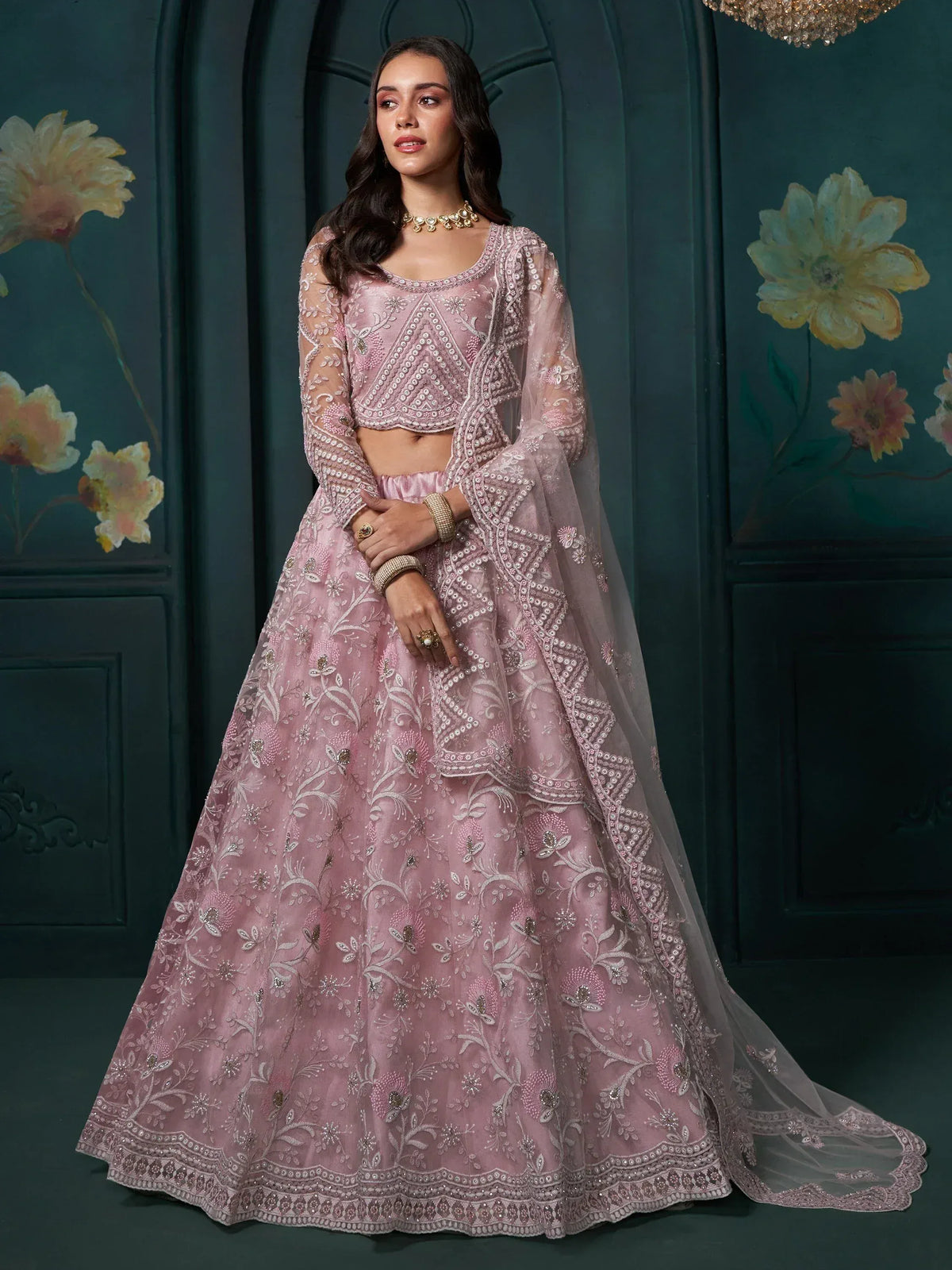 Pink embroidered lehenga choli with floral motifs, perfect for Indian weddings and festive occasions.