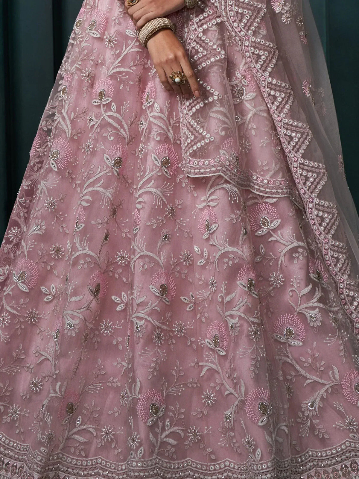Pink floral embroidered lehenga choli with intricate beadwork and sheer dupatta, perfect for Indian weddings