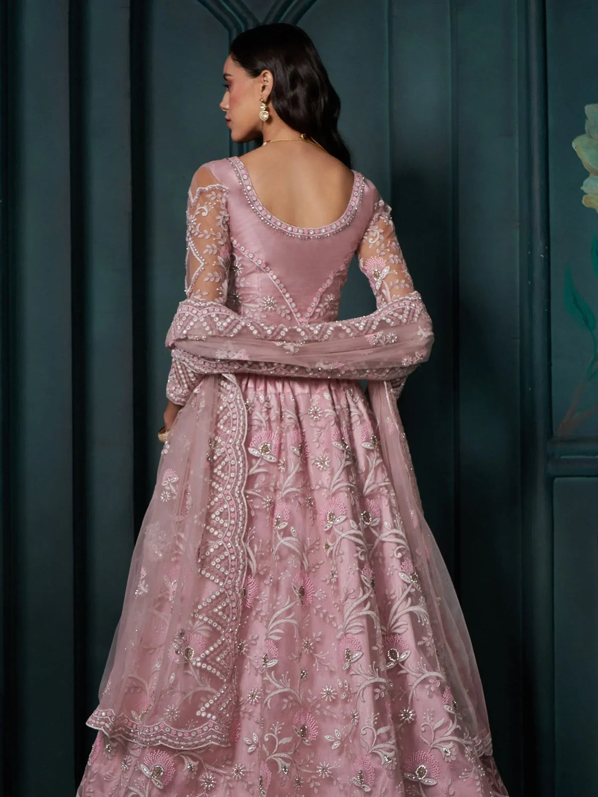 Pink embroidered lehenga choli with sheer sleeves and floral detailing, perfect for Indian ethnic wear