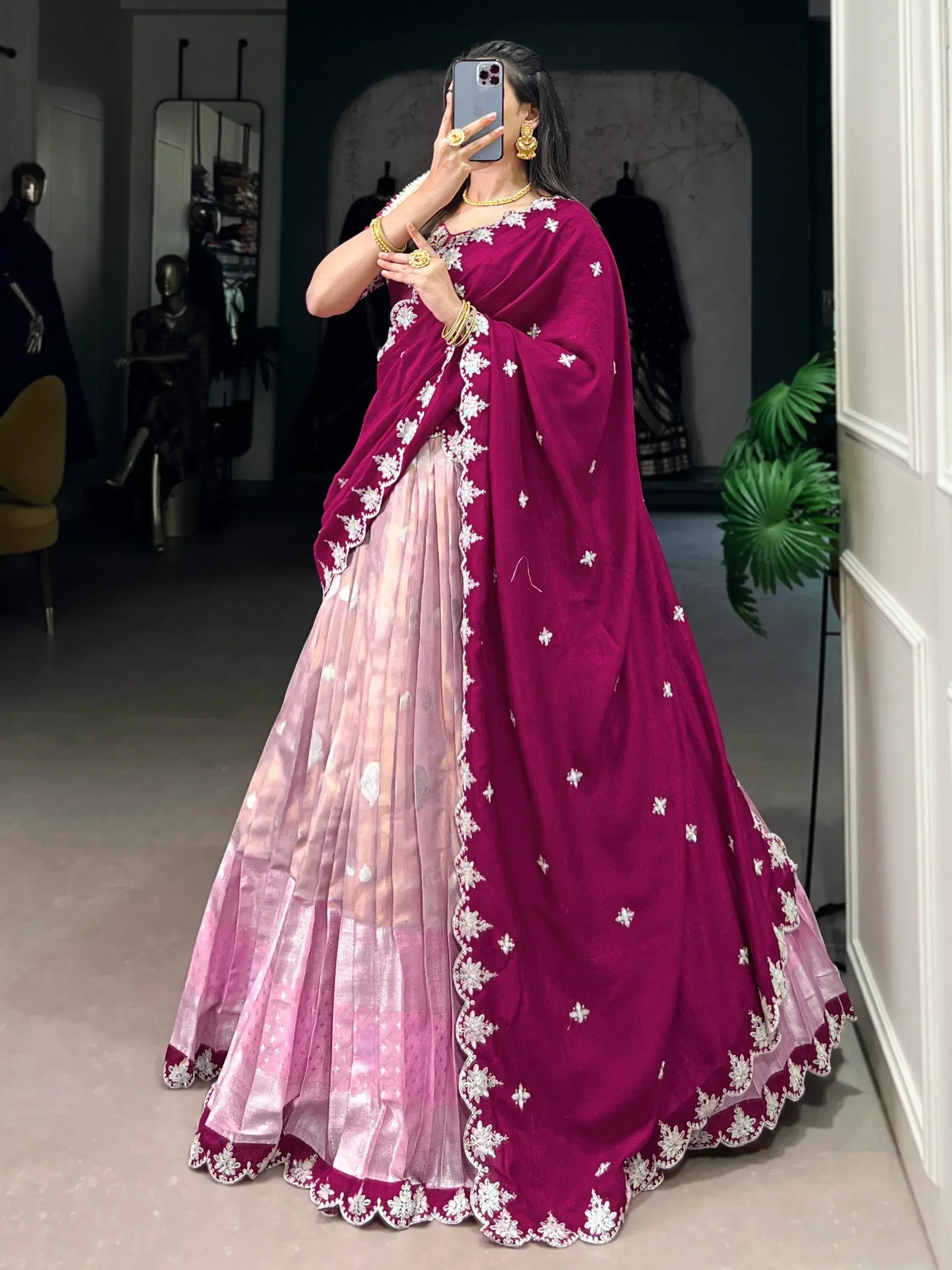 Woman in maroon and pink embroidered lehenga choli with floral detailing, perfect for Indian ethnic wear occasions