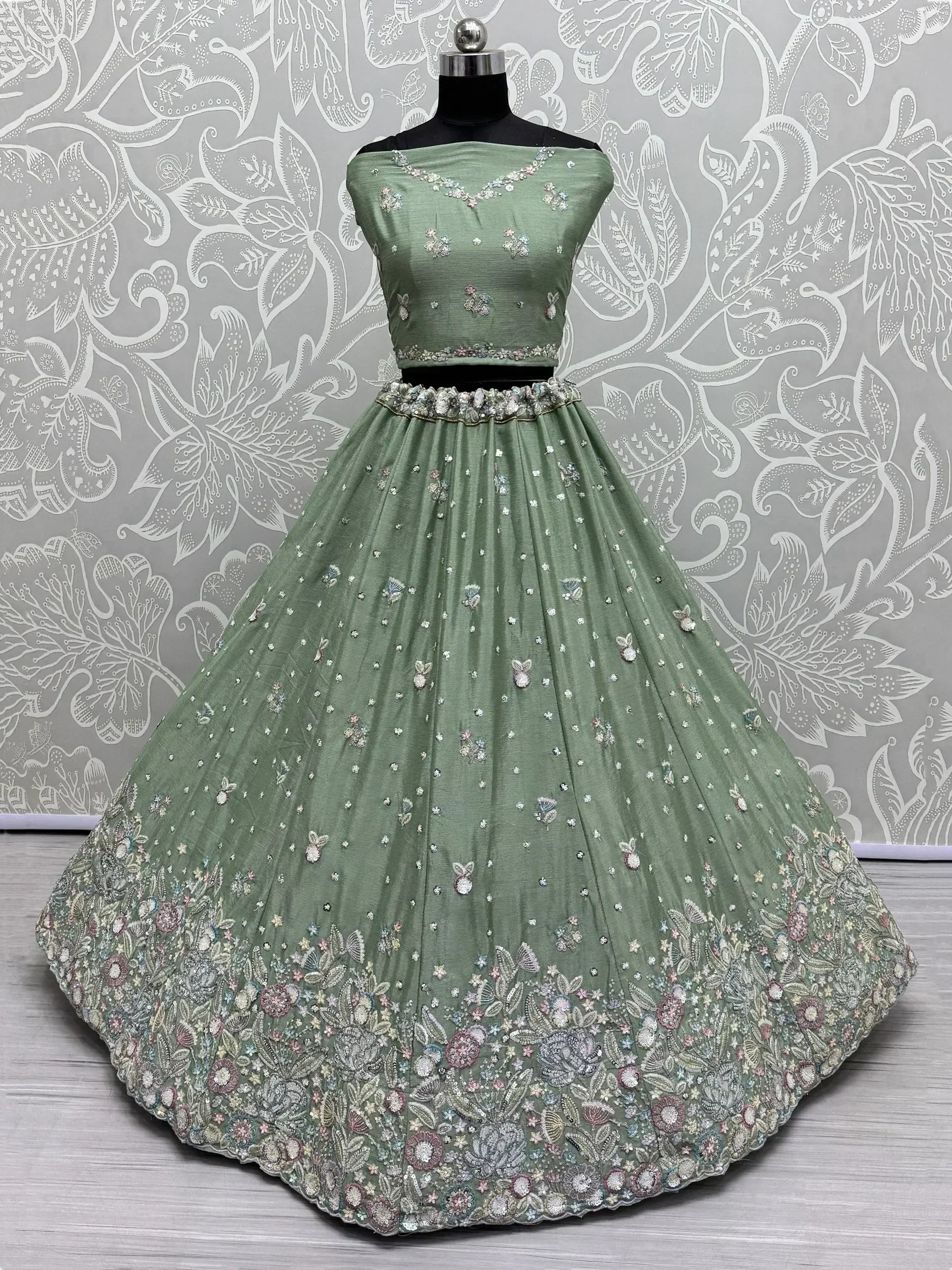 Mint green designer lehenga choli with floral embroidery and embellished border, perfect for Indian ethnic wear.