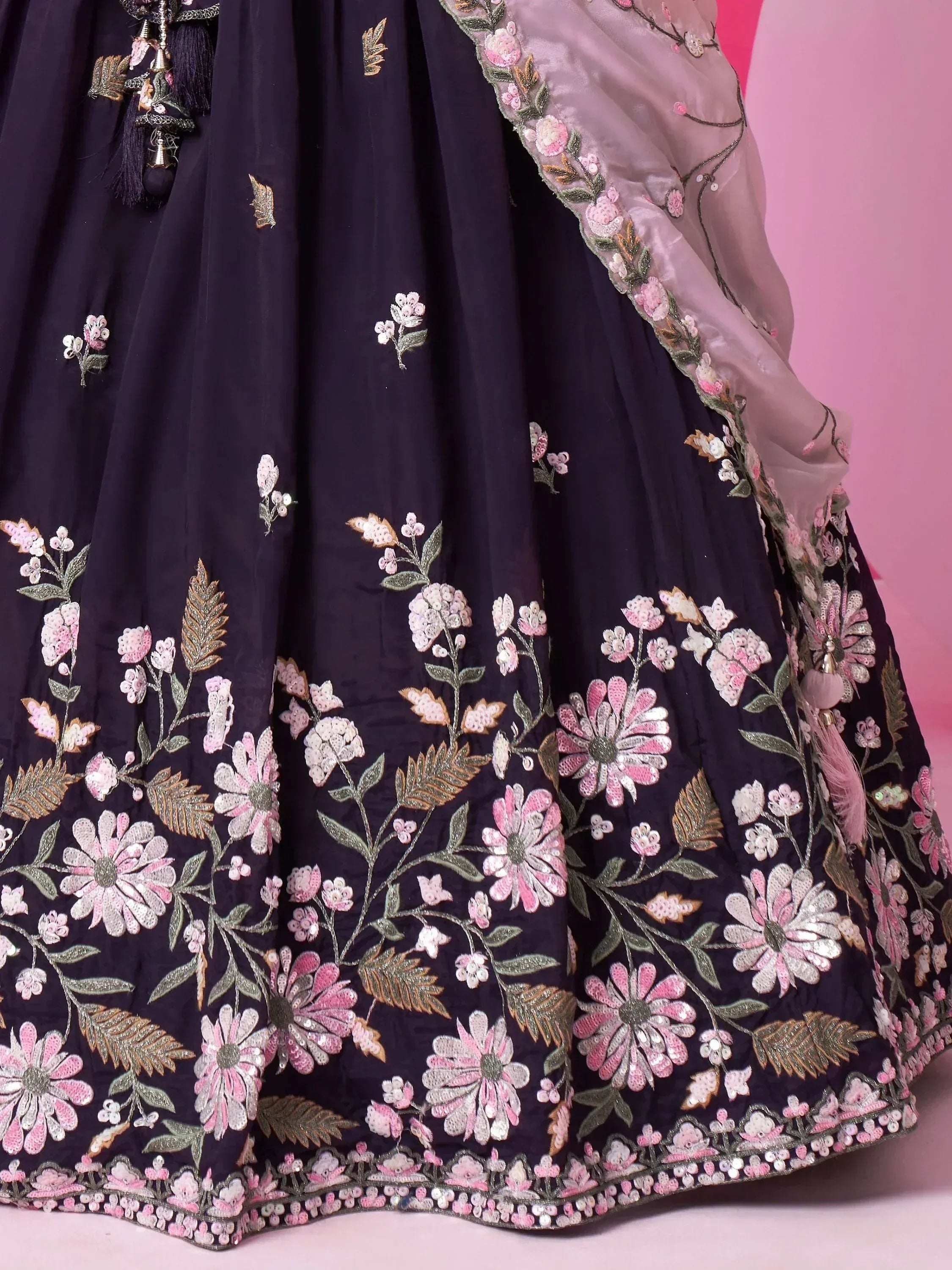 Dark blue lehenga with pink floral embroidery and sequin work, paired with sheer dupatta for Indian ethnic wear
