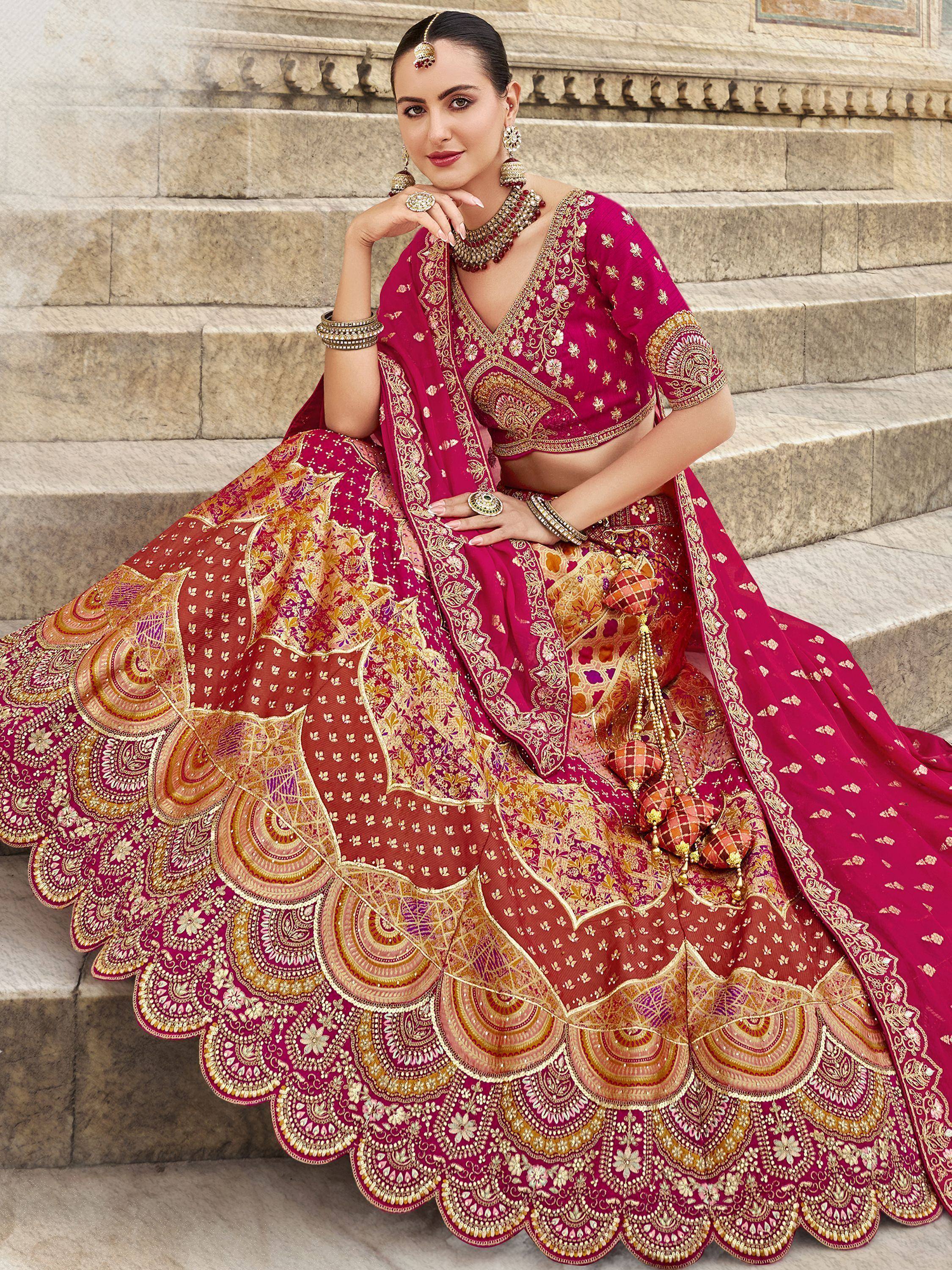 Elegant magenta lehenga choli with gold embroidery, perfect for Indian weddings and festive occasions.
