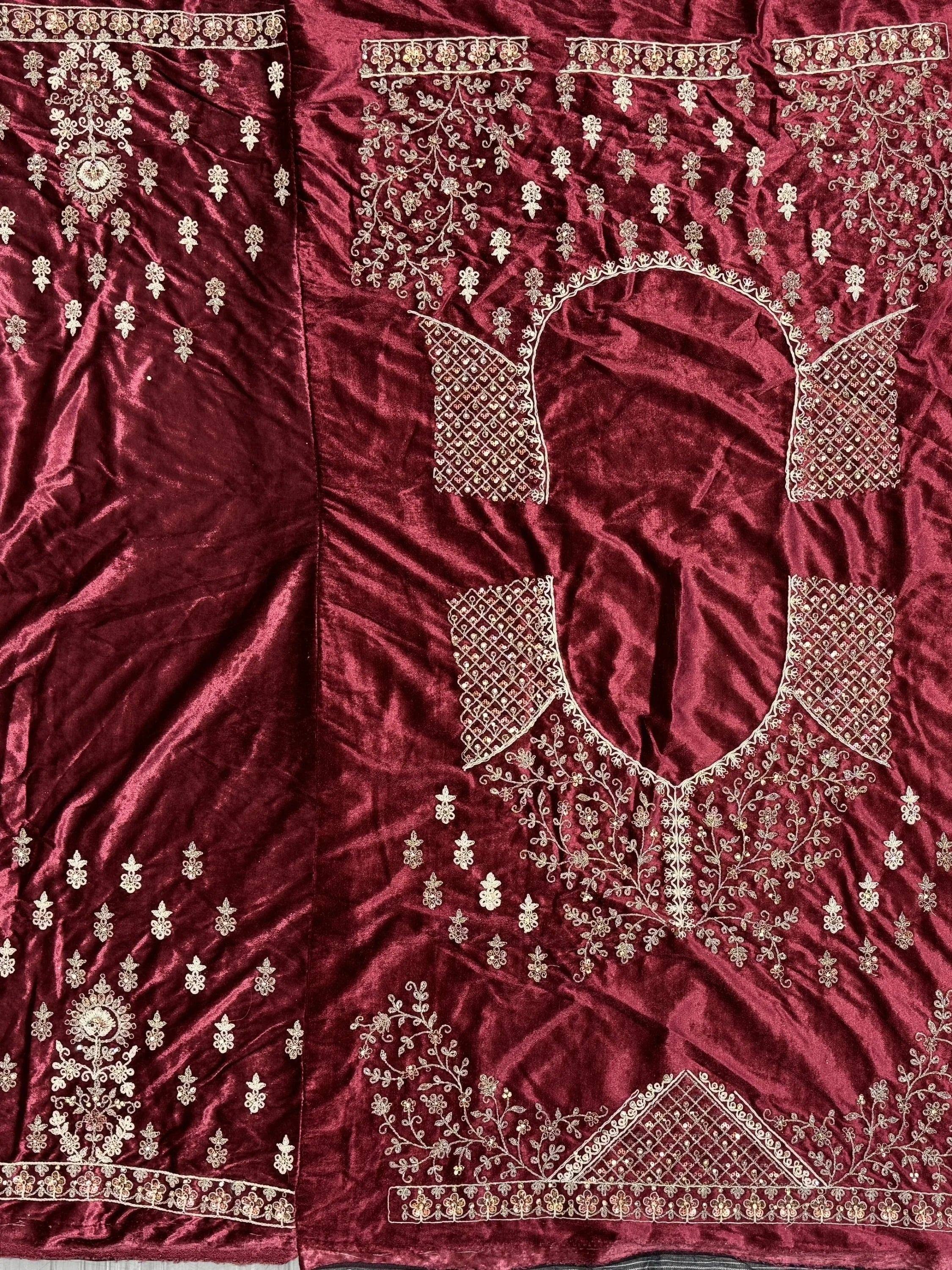 Maroon velvet ethnic gown with gold floral embroidery and detailed neckline design