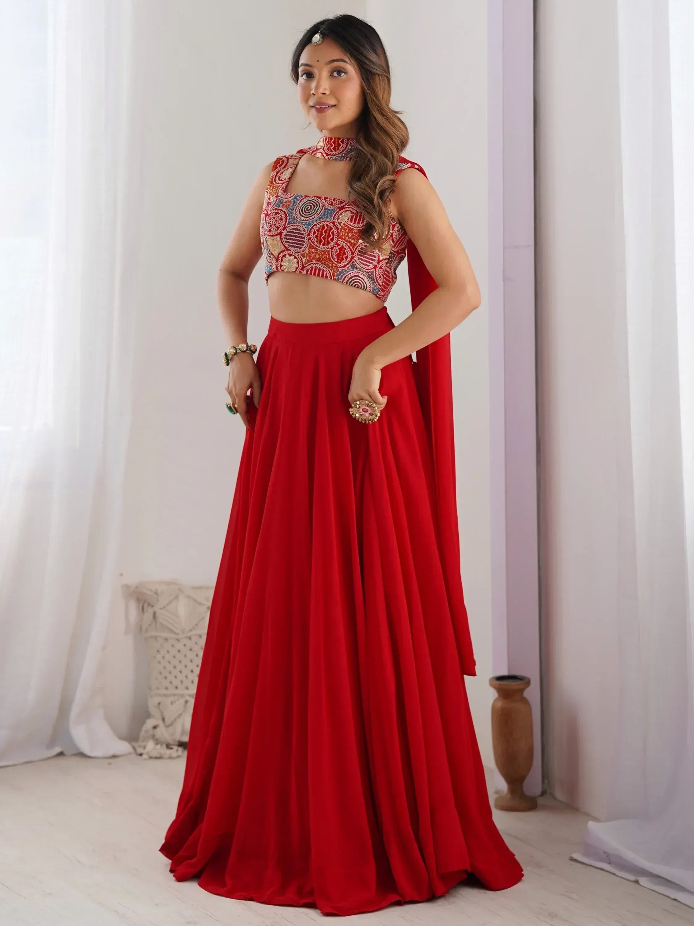 Red lehenga choli with embroidered crop top and flowing skirt, perfect for Indian ethnic wear occasions