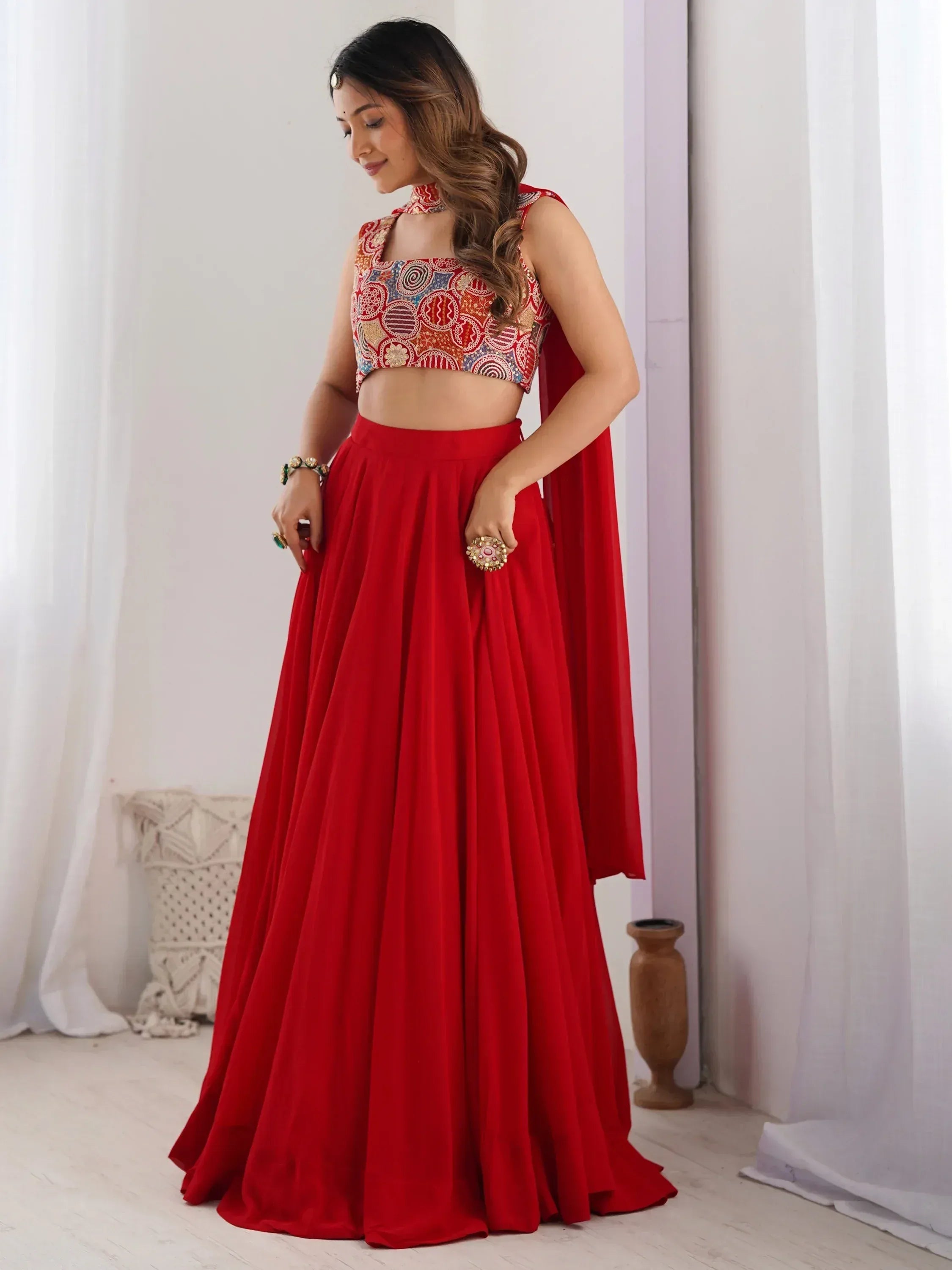 Red lehenga choli with embroidered crop top and flowing skirt, perfect for Indian ethnic wear occasions