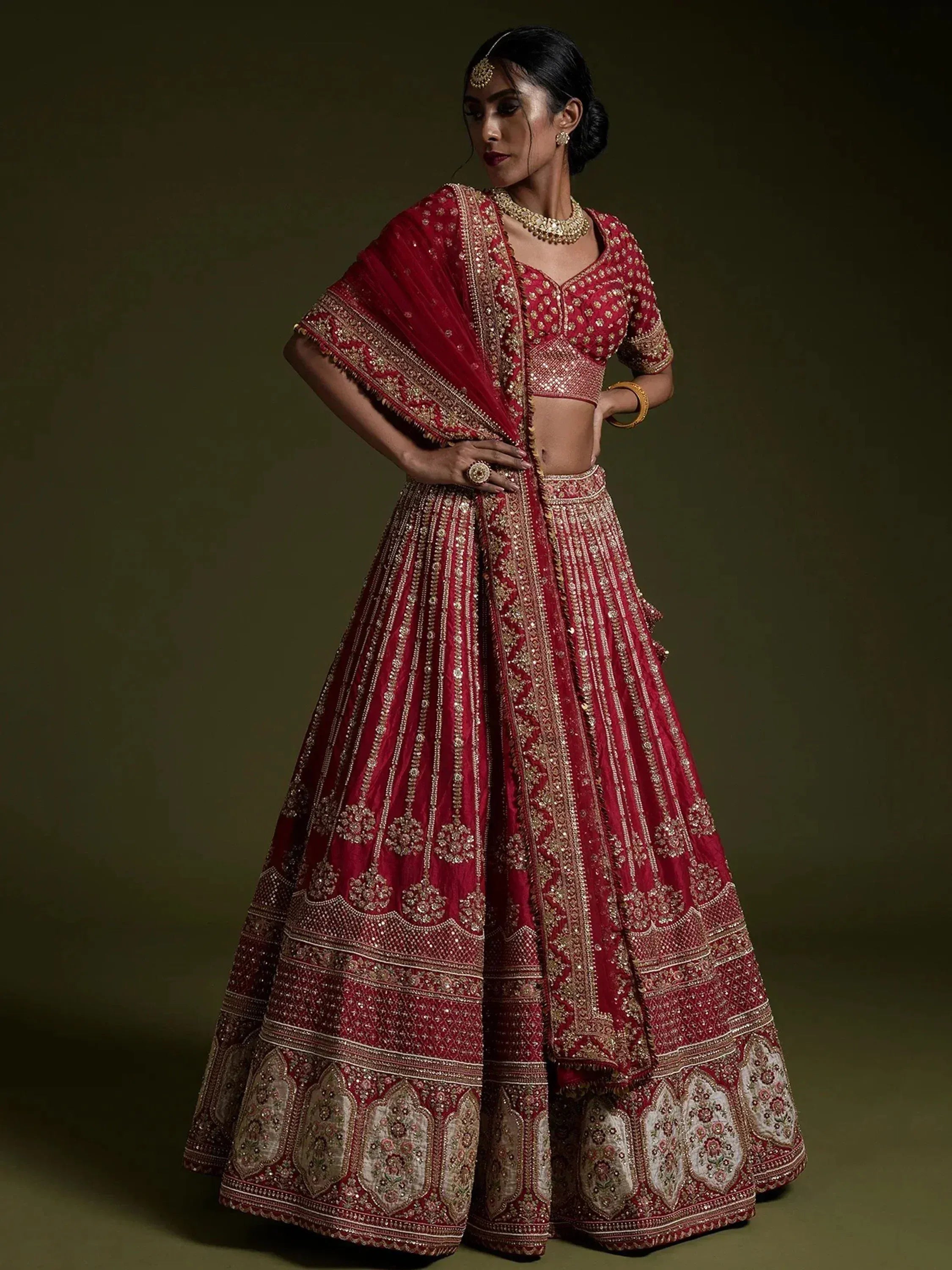Red embroidered lehenga choli with gold detailing, perfect for Indian weddings and festive occasions