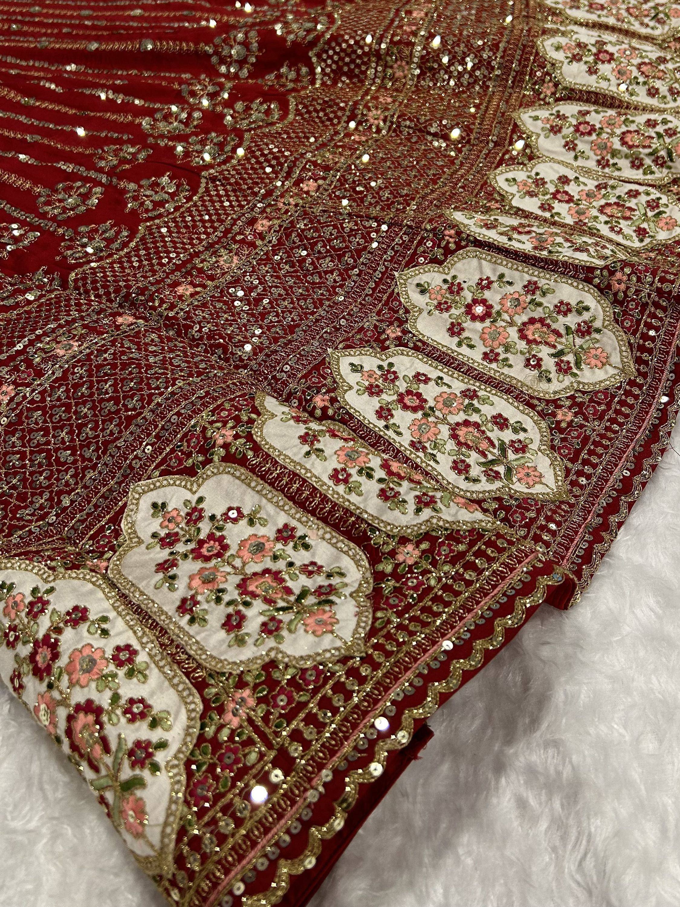 Red velvet lehenga with gold embroidery, floral motifs, and sequin detailing for Indian ethnic wear