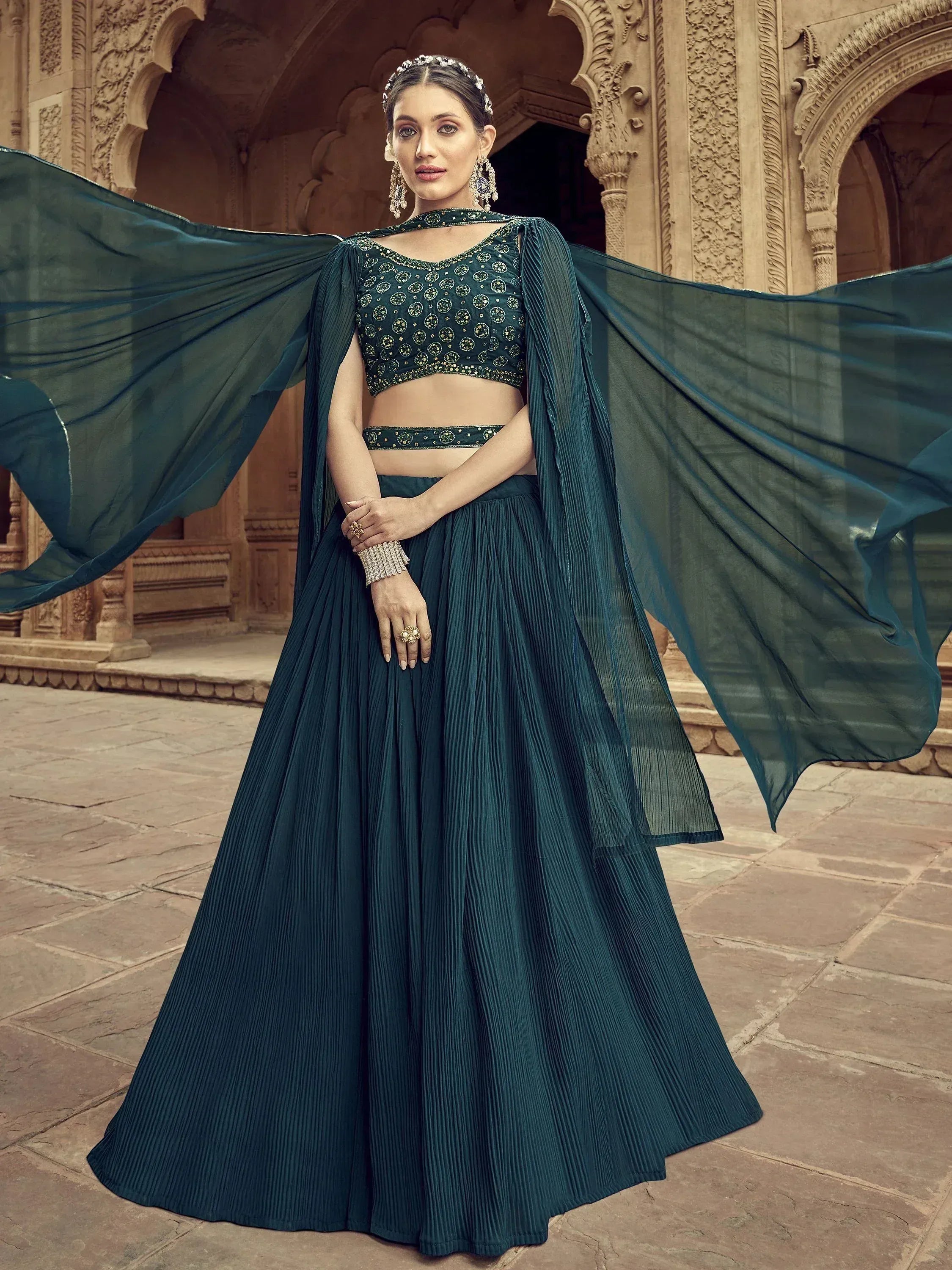 Emerald green designer lehenga choli with cape, perfect for Indian weddings and festive occasions.
