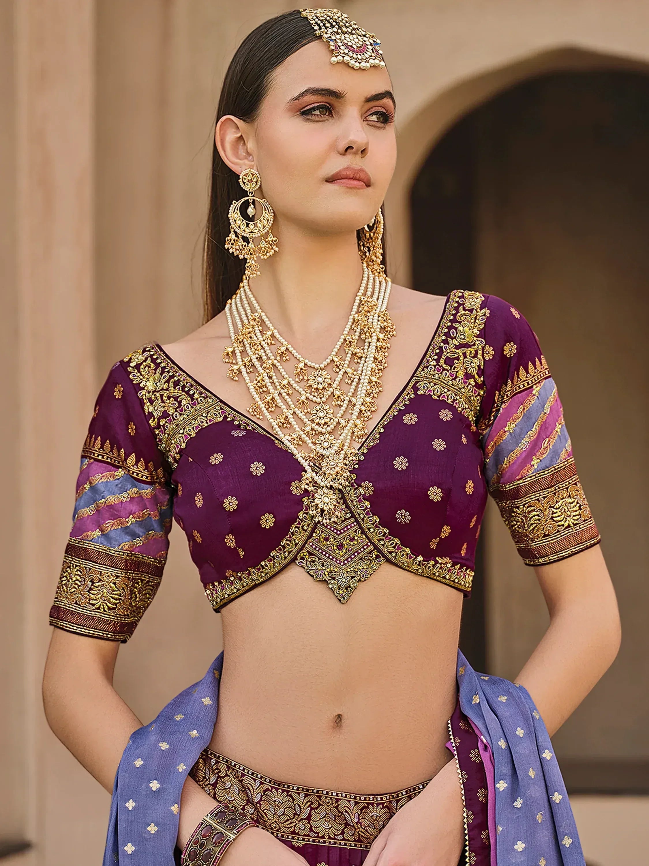 Purple embroidered lehenga choli with gold detailing, traditional Indian ethnic wear for women